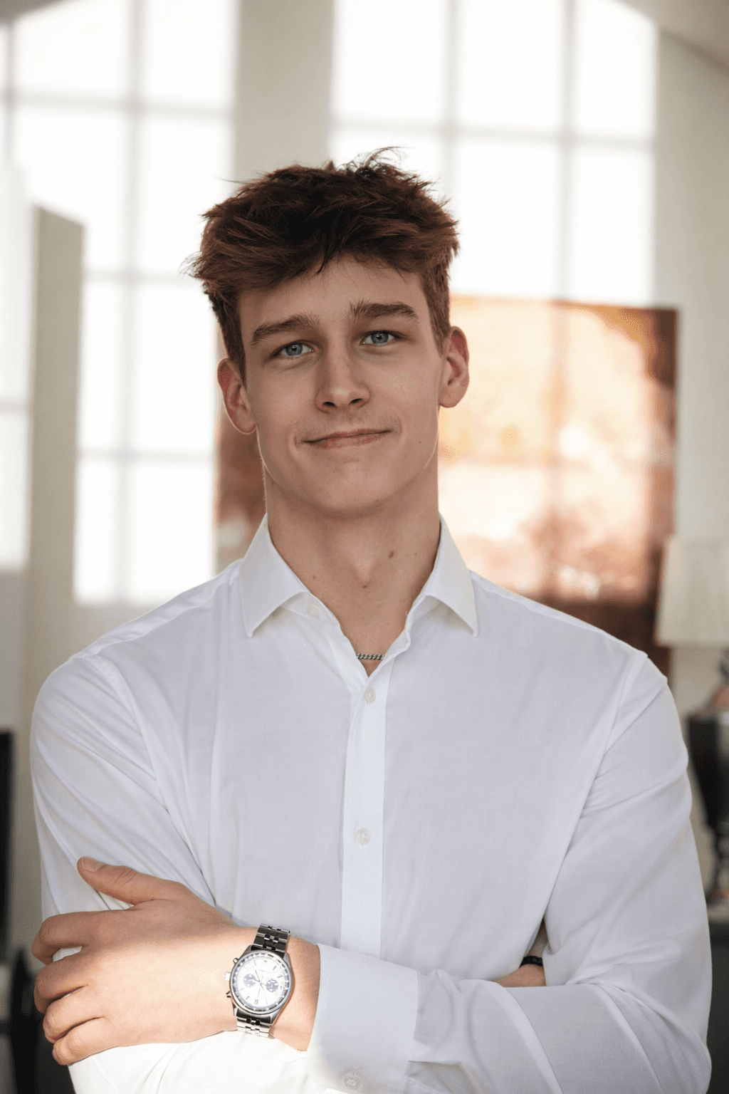 Portrait of a person in a pink sweater against a light background