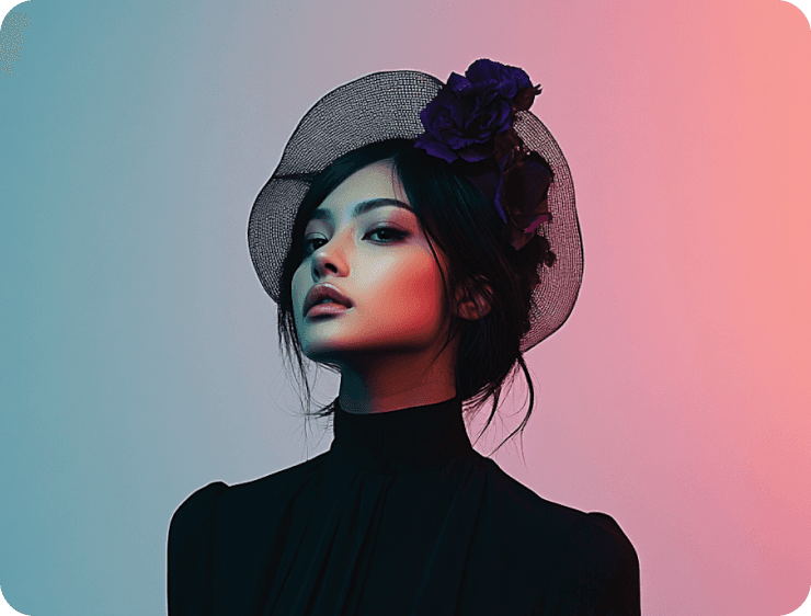 A woman in a black dress poses with elegance, wearing a stylish netted hat adorned with purple flowers, set against a softly lit pink and blue gradient backdrop.