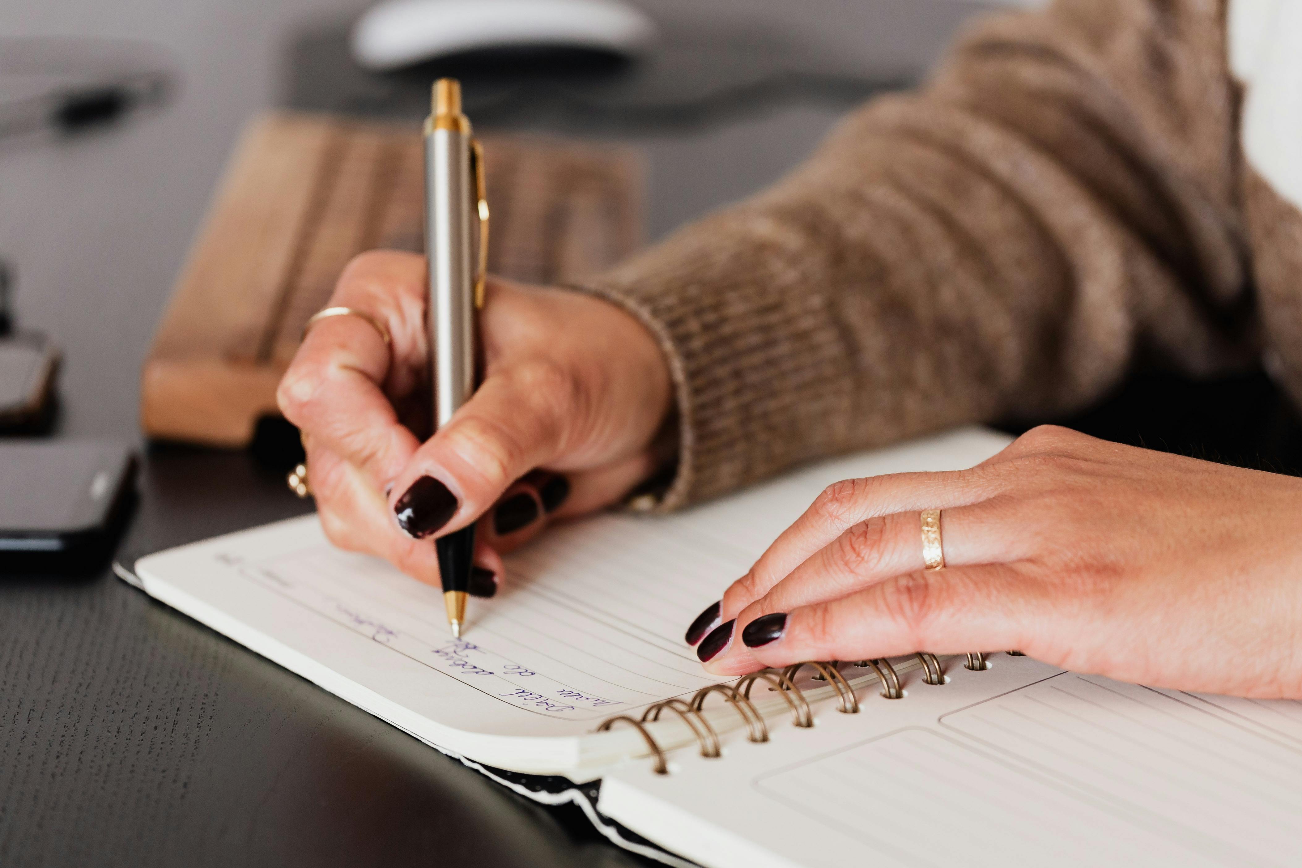 woman writing letter on notebook