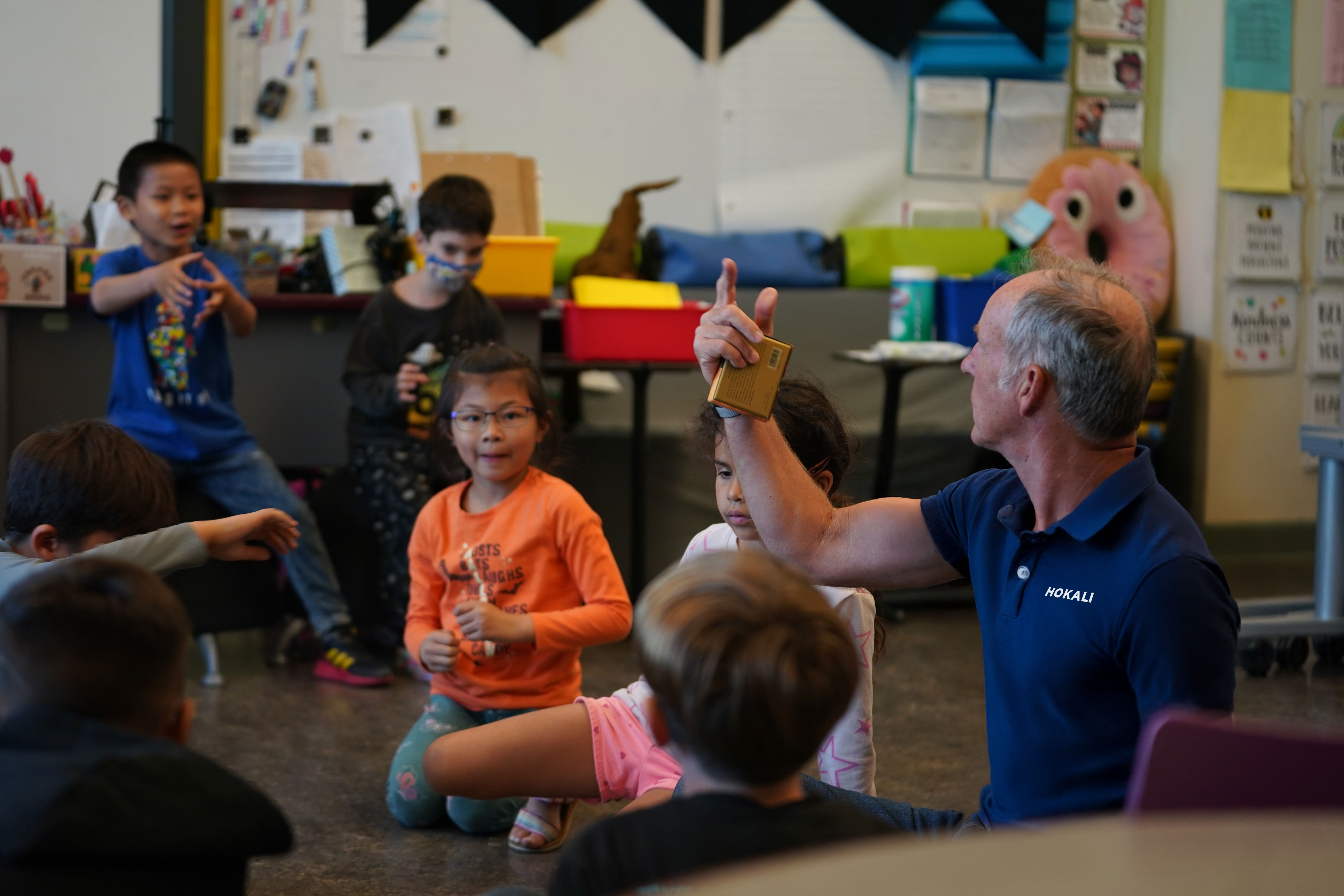 HOKALI aftercare educator leading a group activity with elementary students in a safe, engaging classroom environment.