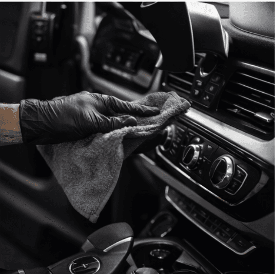 A serene and elegant spa space with wooden reclining chairs and white cushions. Golden sunlight filters through a cascading water feature, creating a peaceful atmosphere. Tropical plants and candles add to the relaxing ambiance.