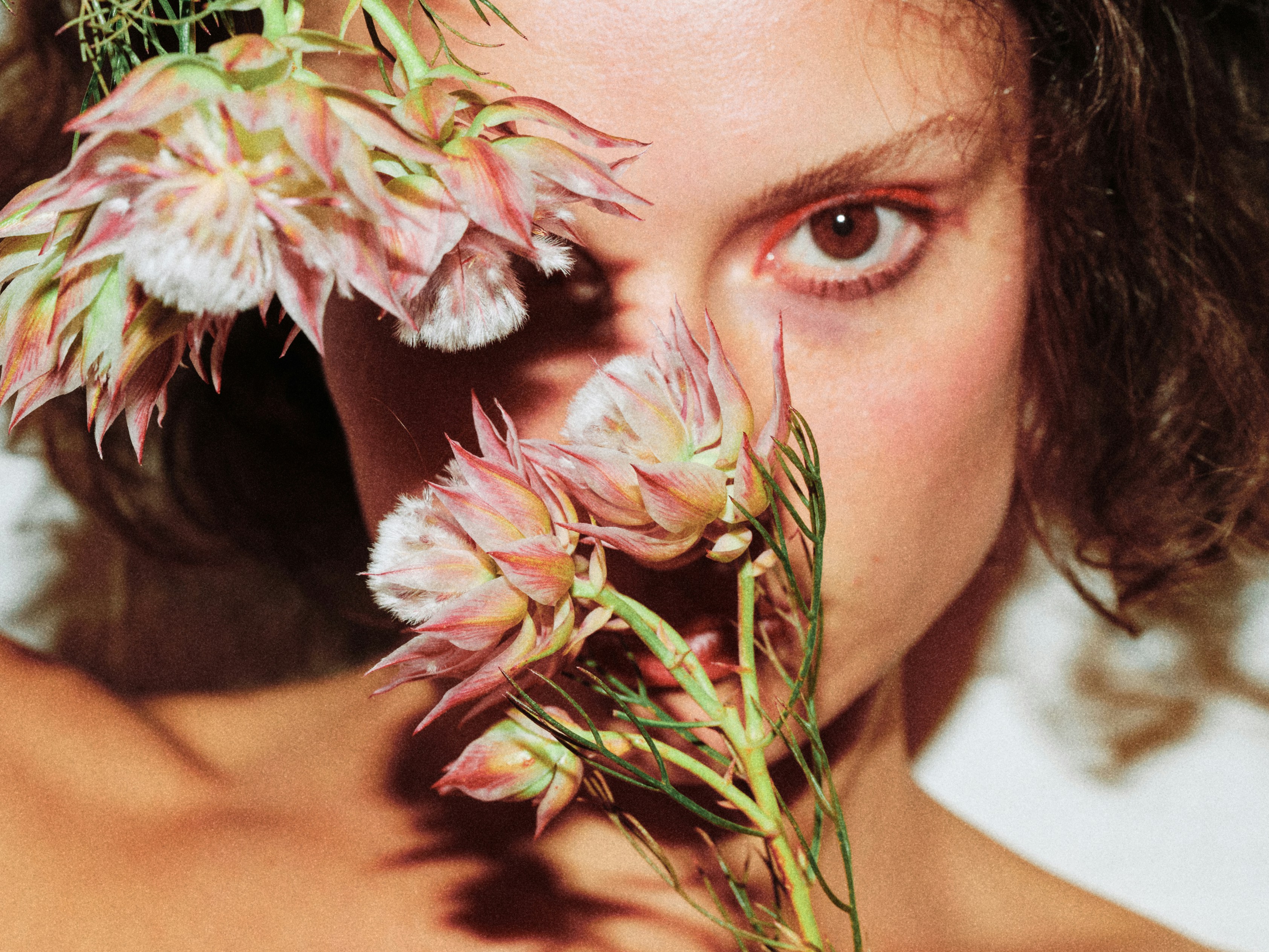 woman holding a bunch of flowers up to her face