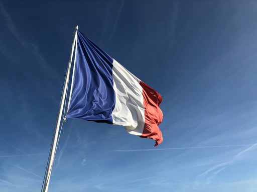 French flag under blue sky illustrating the french citizenship