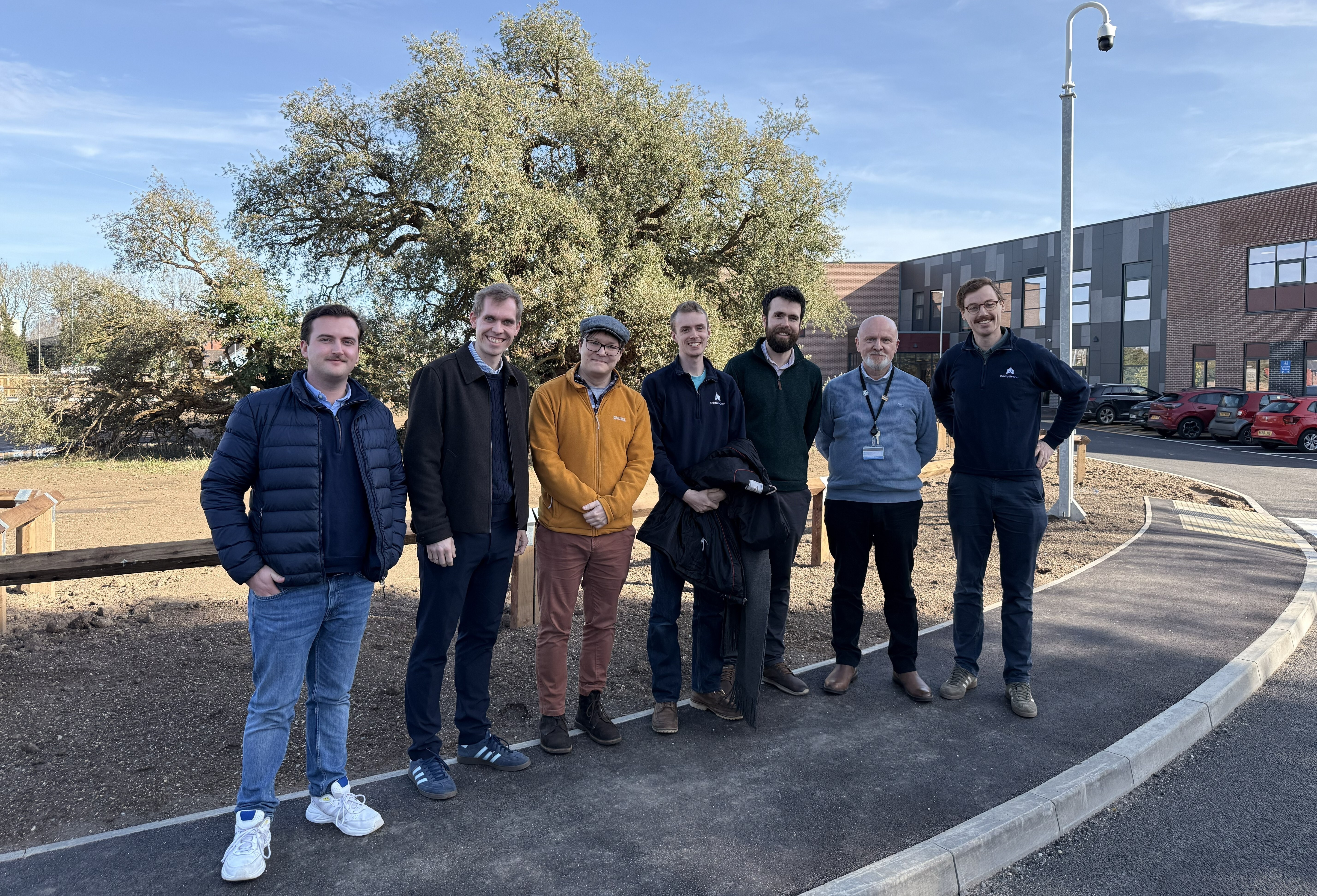 The CompliMind team at Norton Lea with the protected 150-year-old oak tree behind the group