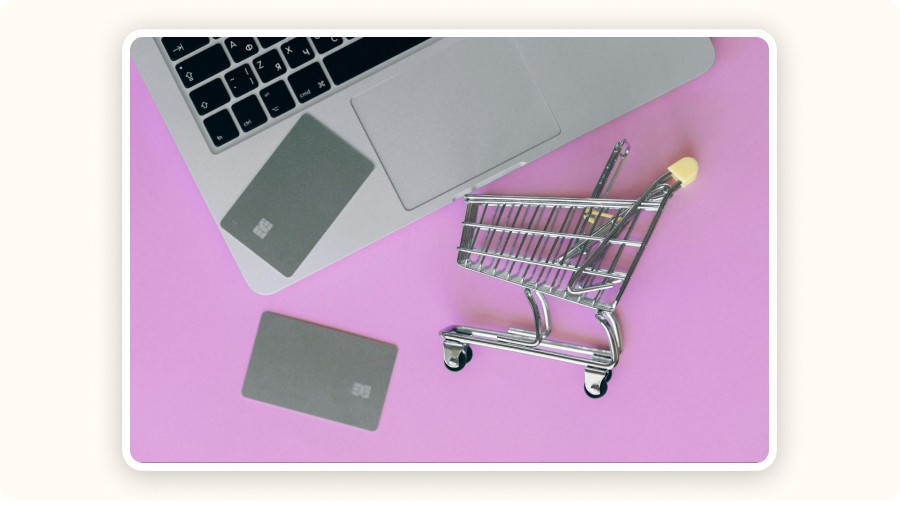 mini cart and credit card in front of a laptop