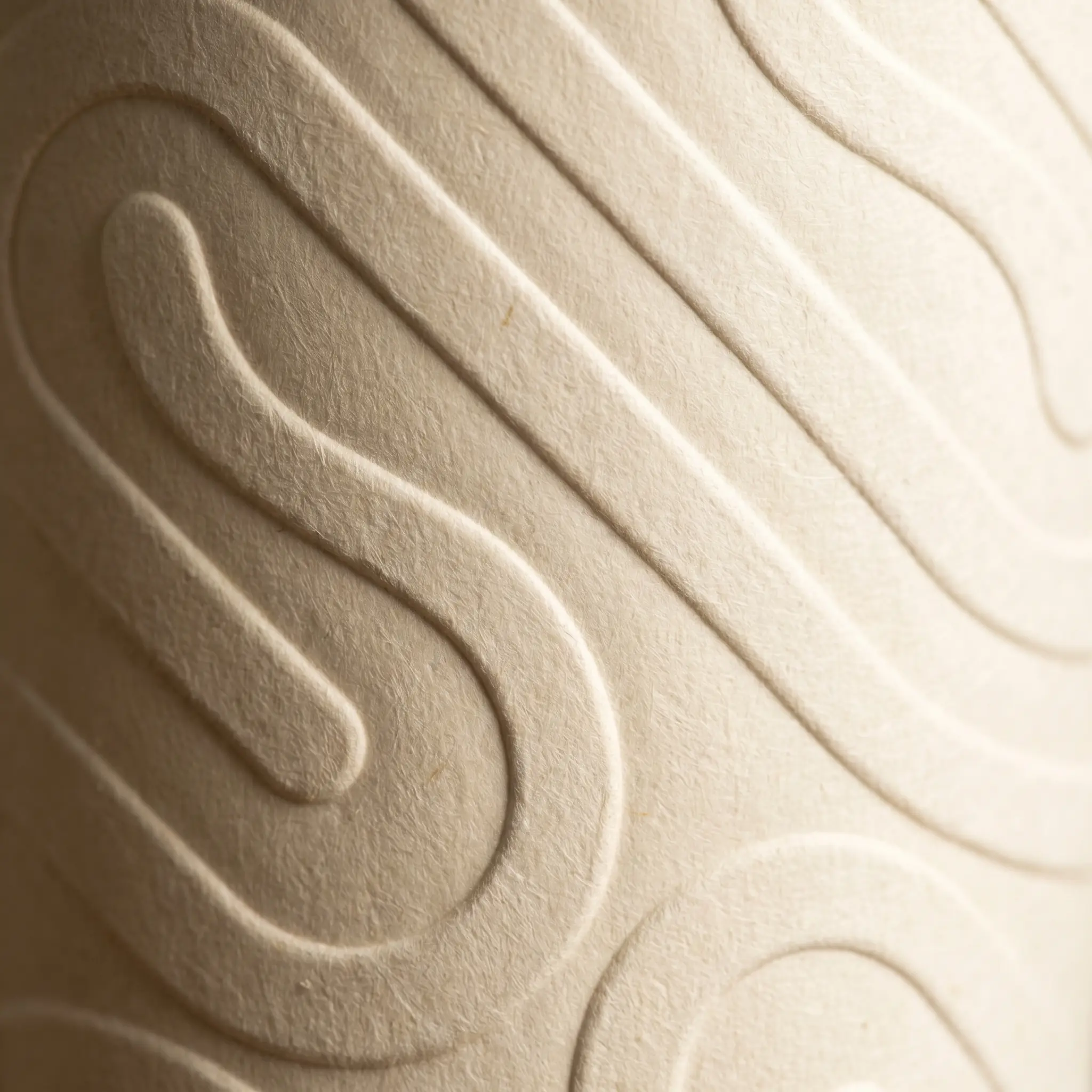 Close-up of the embossed Willow & Hearth pattern on cream card