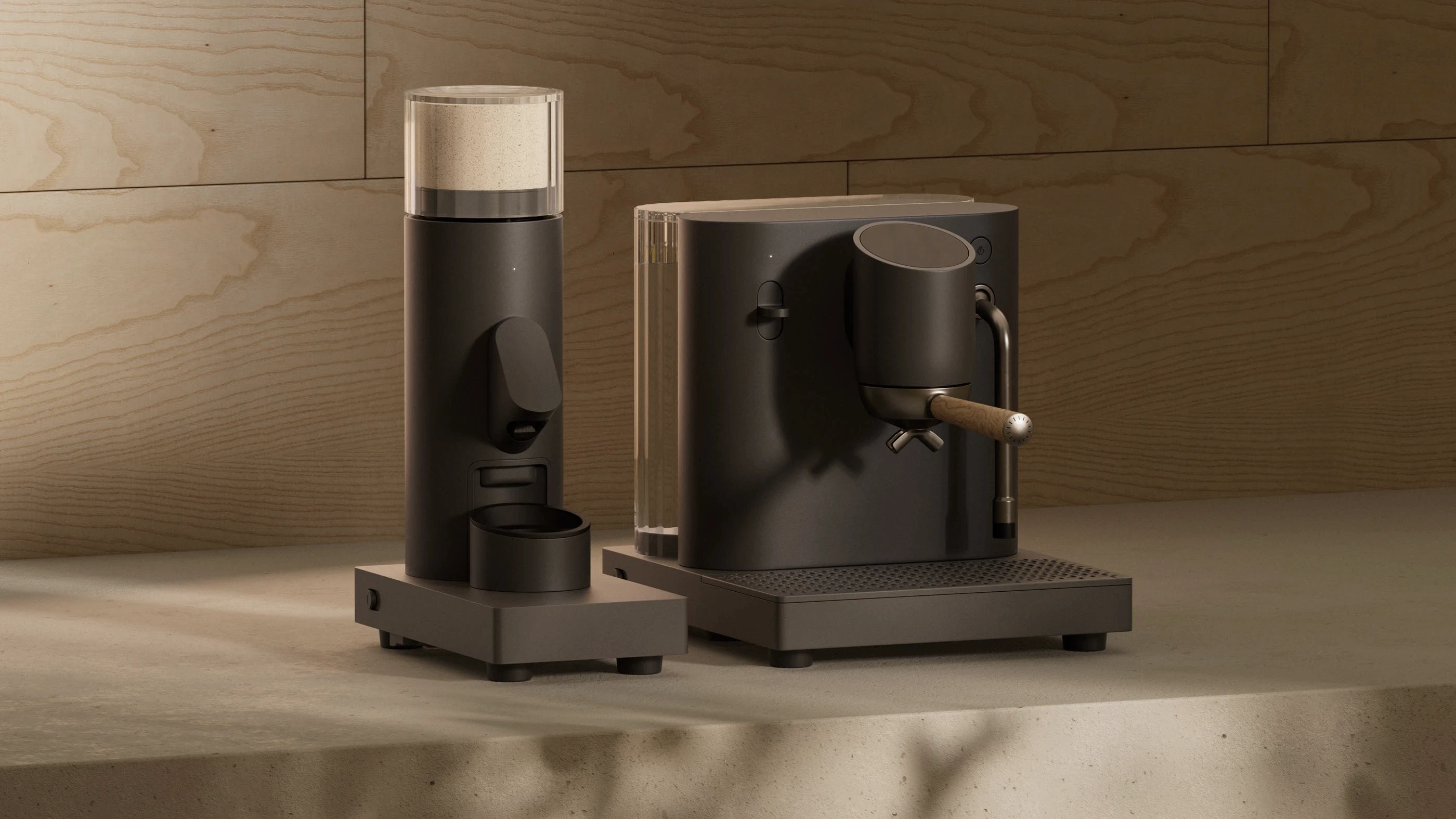 Stylish black espresso machine and grinder on a textured beige counter. Warm lighting casts soft shadows, creating a modern and inviting ambiance.
