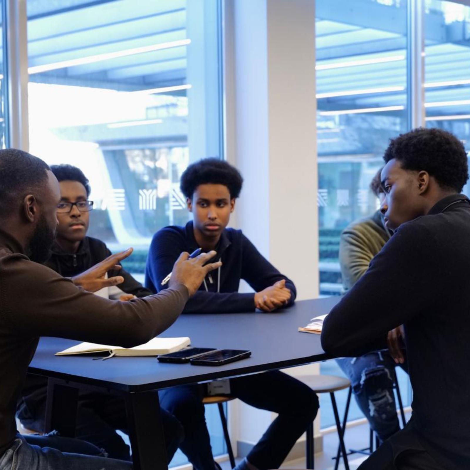 Colleagues talking at a table