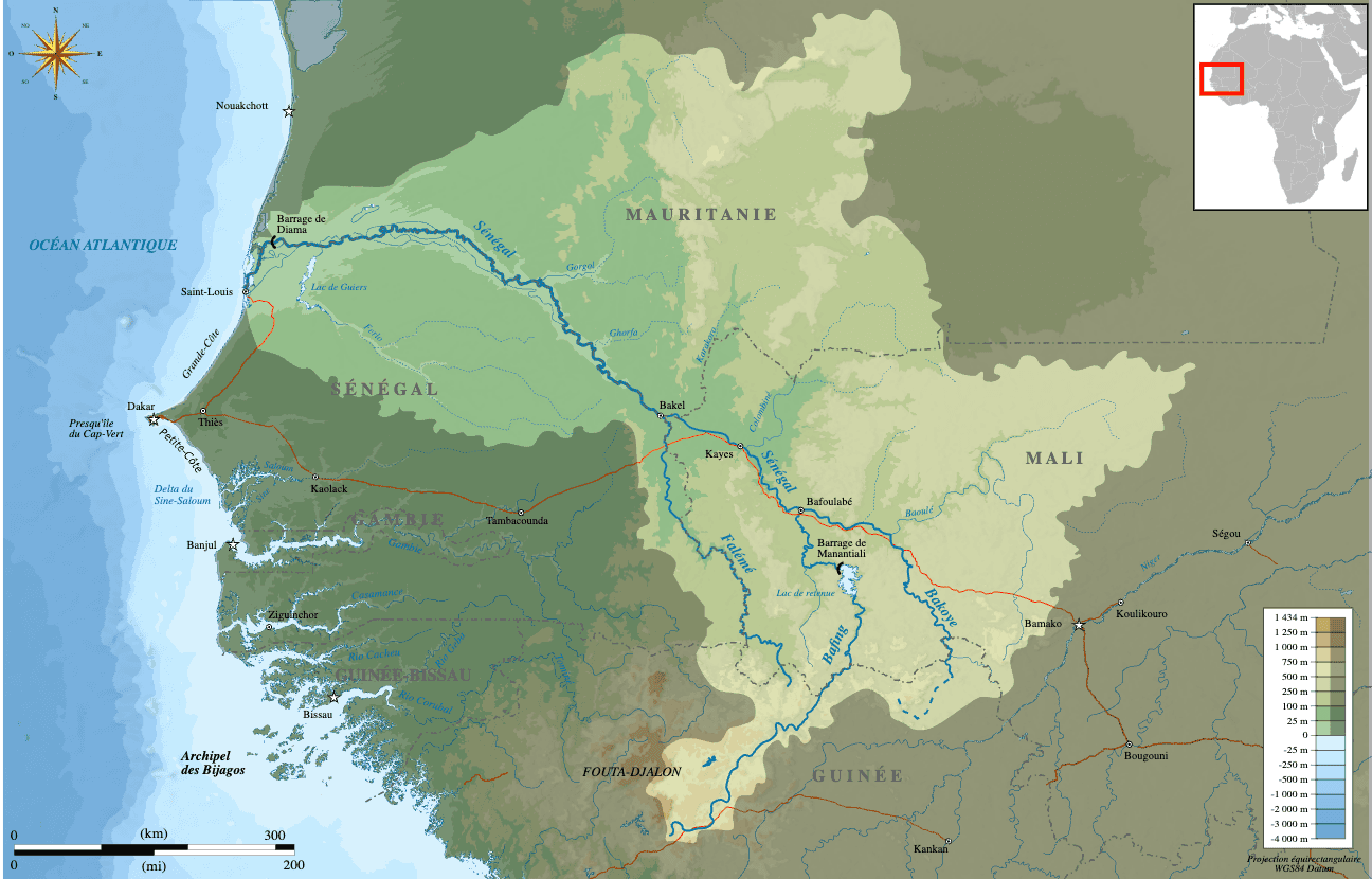Topographic map of the Senegal River Basin in West Africa, showing the river and its tributaries across Senegal, Mauritania, Mali and Guinea, with major dams, cities like Dakar and Saint-Louis, and an inset map indicating the basin’s location in Africa.