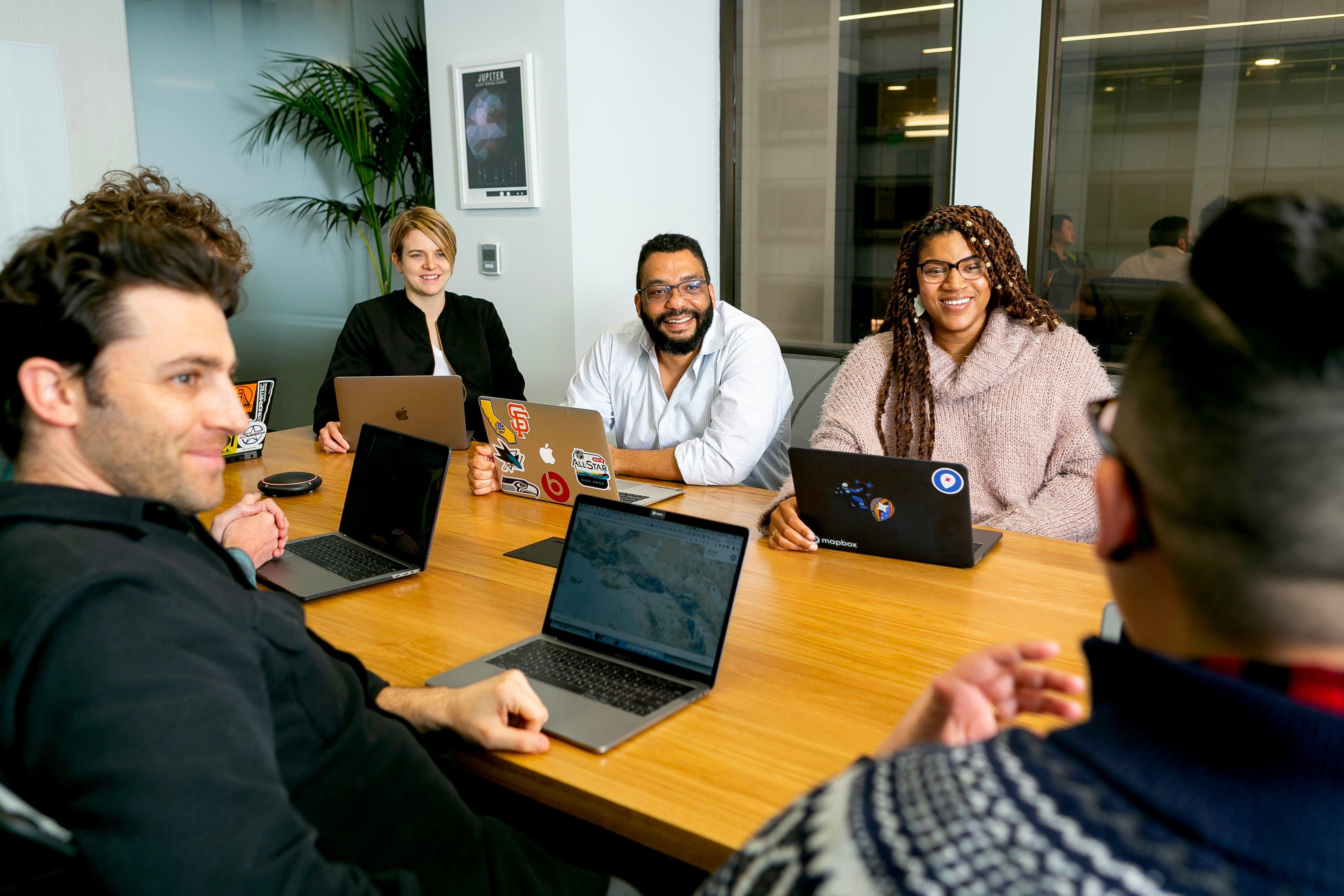 Group of people sitting around a table smiling