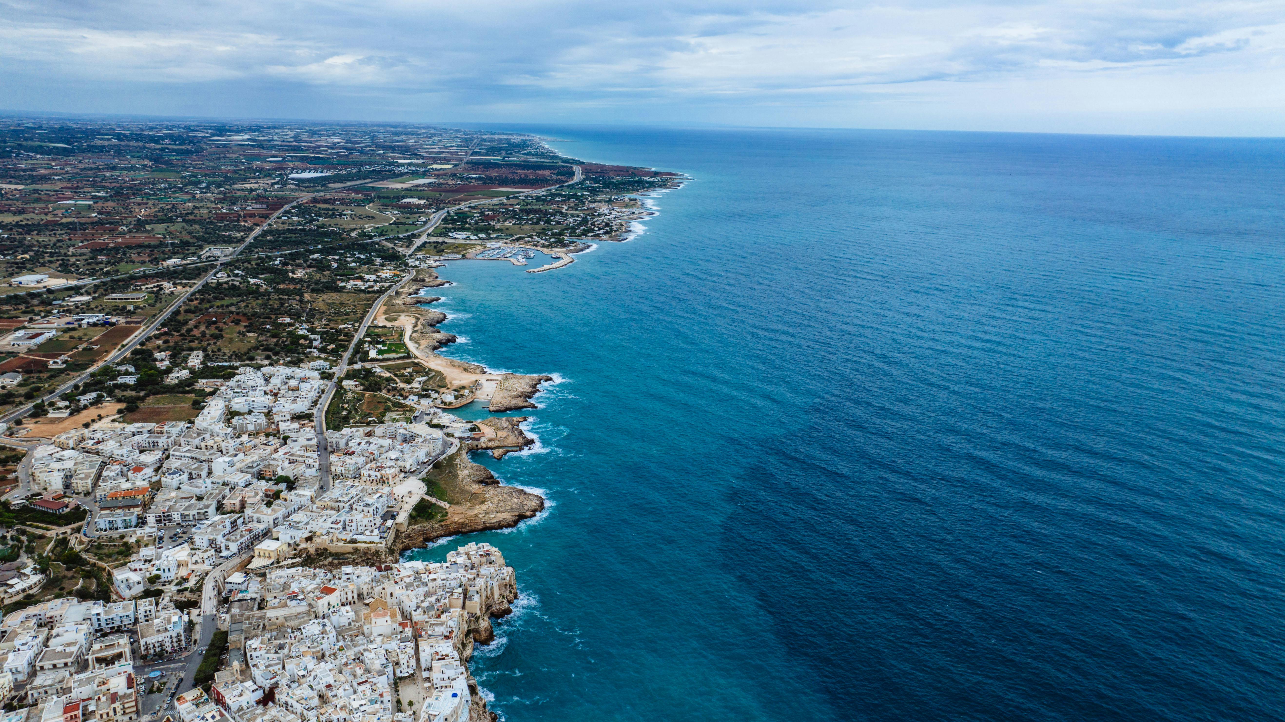 Polignano a Mare, the Adriatic, framed by white stone.