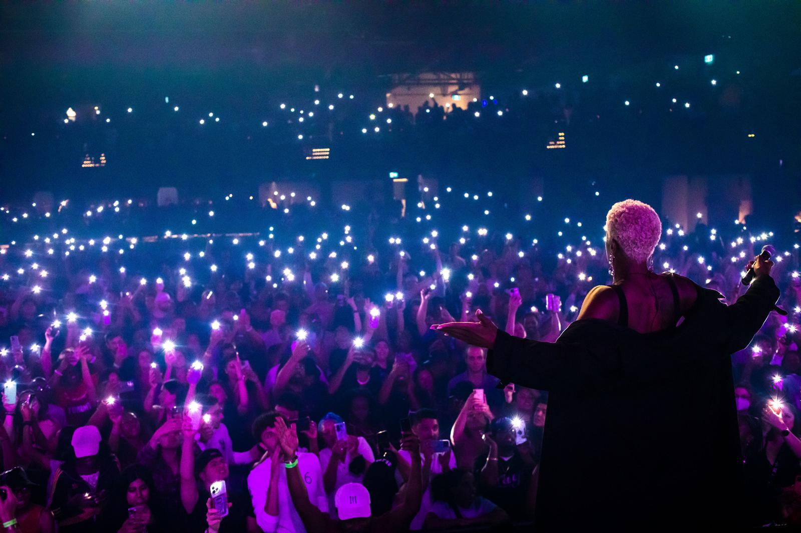 Performer under spotlight on dark stage