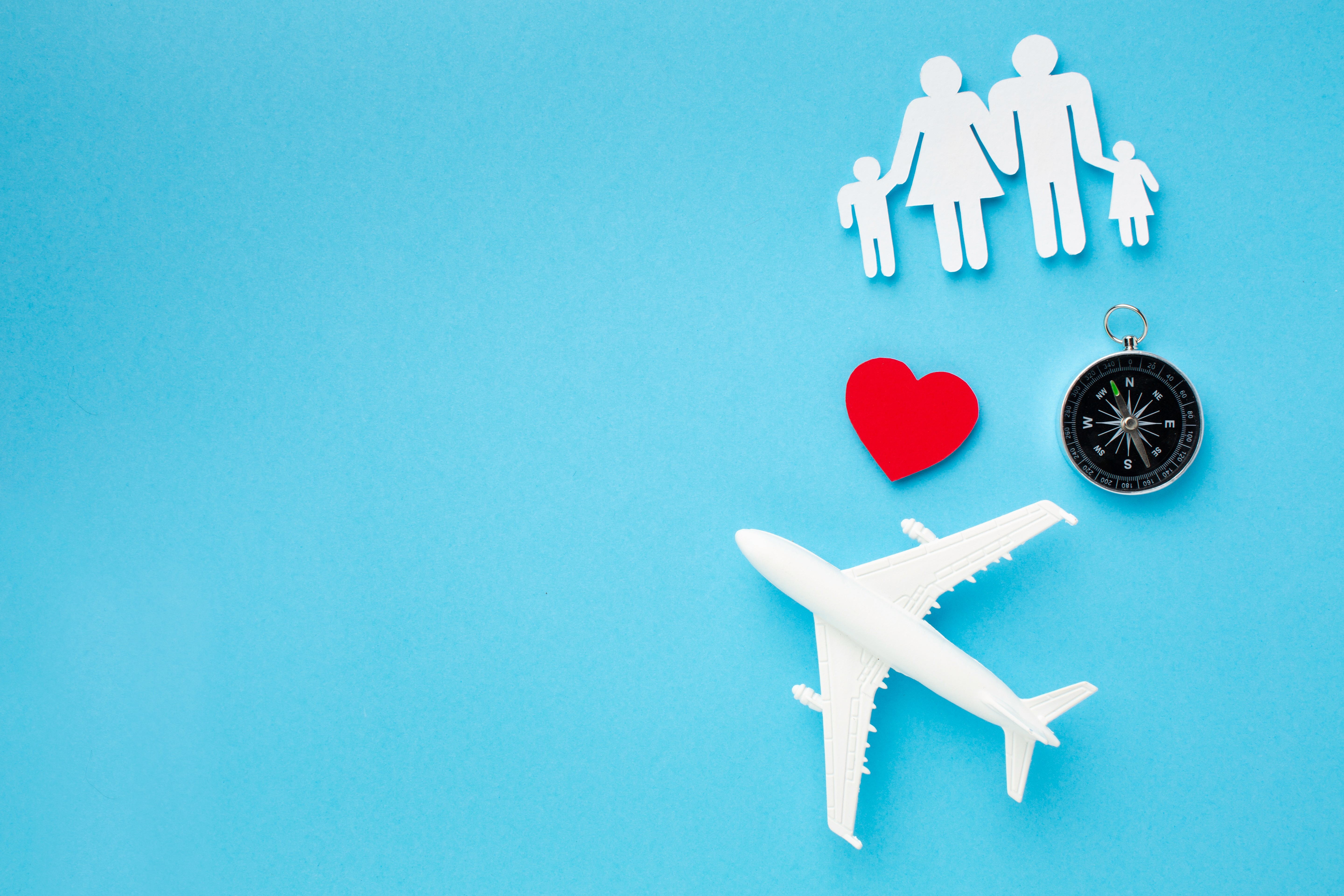 Landscape with a vineyard in rows leading to a building with a tower, rolling hills in the distance.