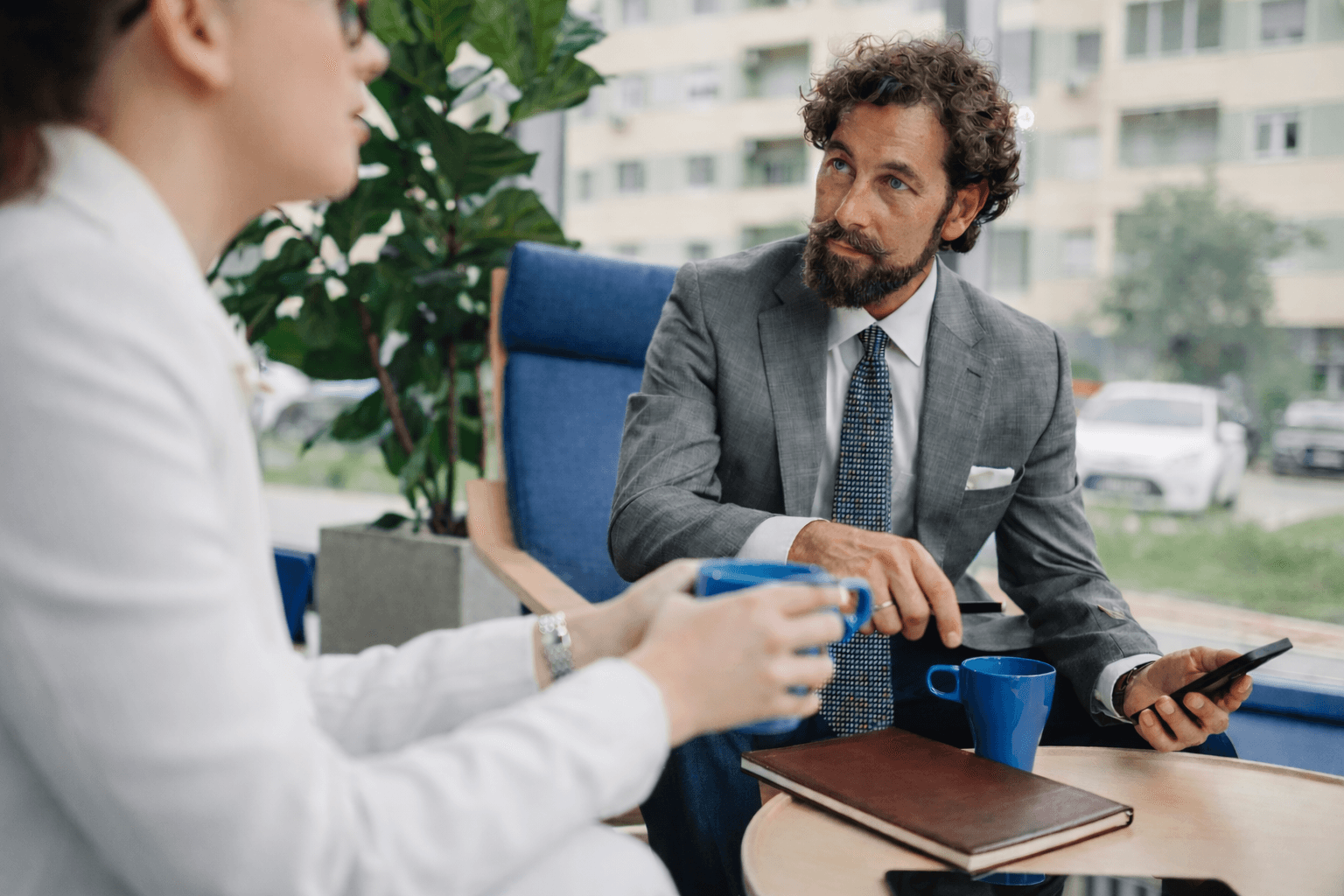 a group of people sitting around a white table