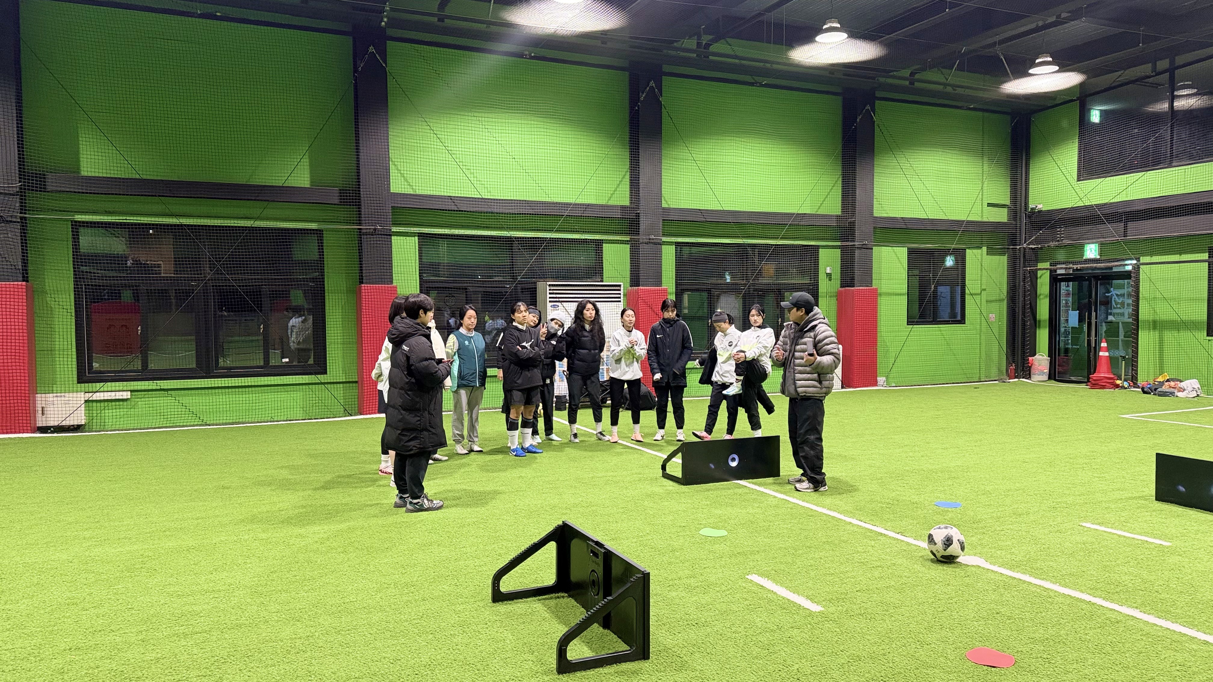 a person's feet with a ball on a purple carpet