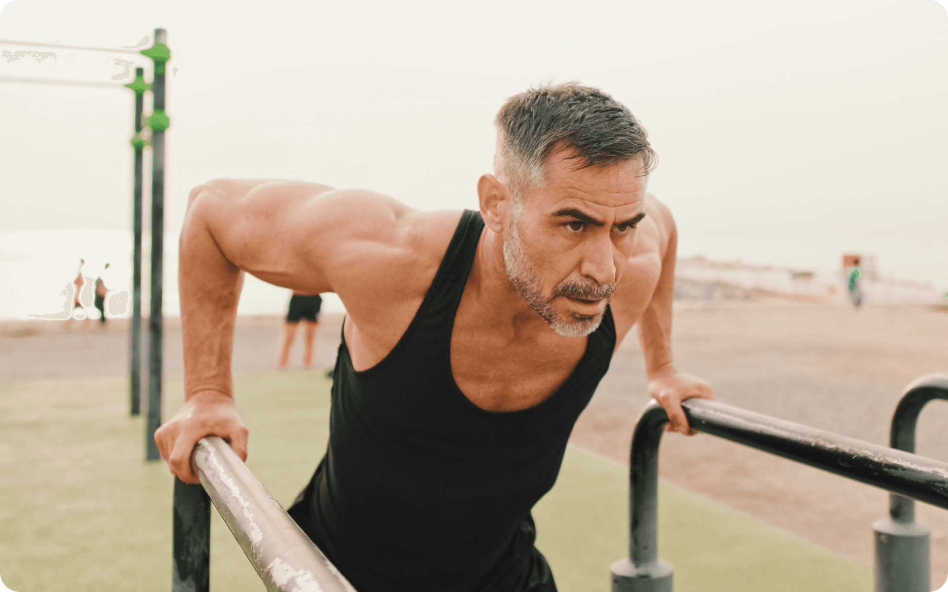 man in black tank top and black shorts lying on brown concrete floor during daytime