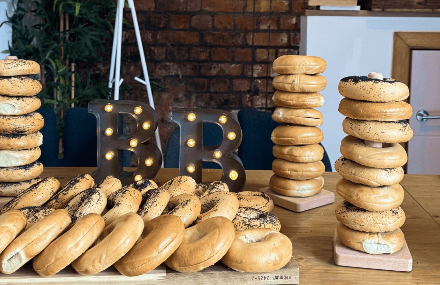 A table with many sandwiches and candles on display.