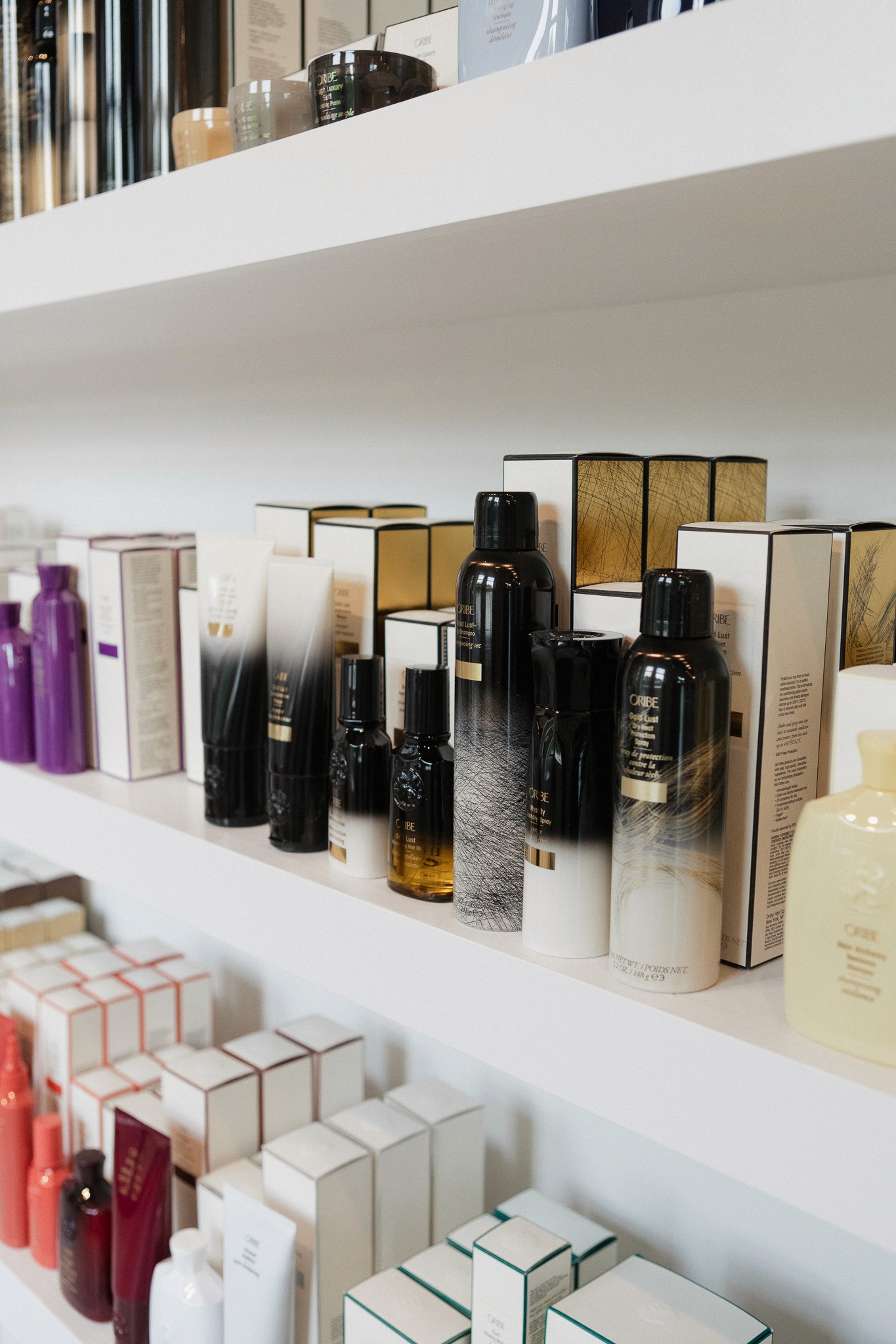 Close-up of a dark green leaf showing its textured surface and central vein against a muted background.