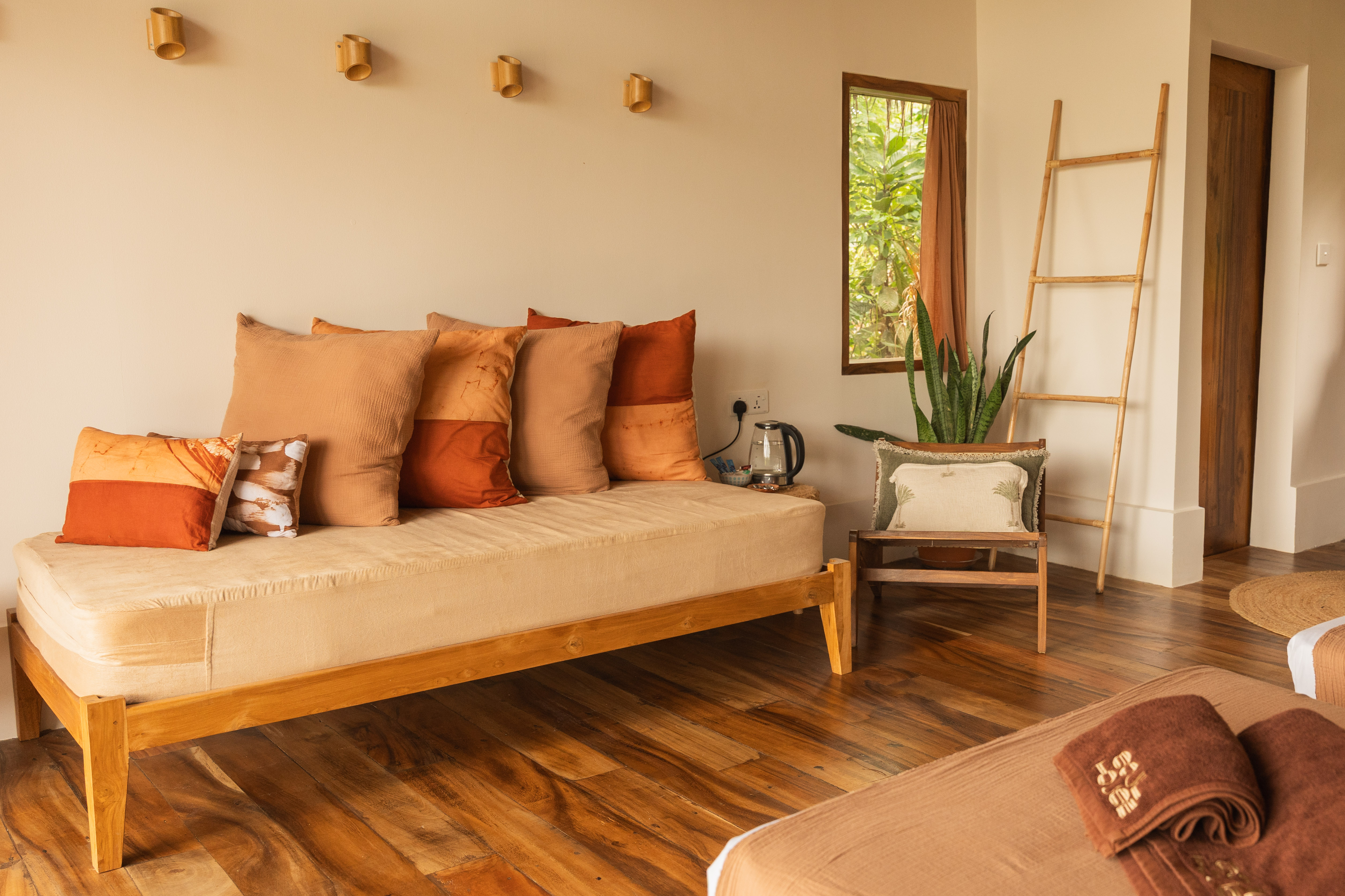 Outdoor dinning area with with chairs next to a pool surrounded by jungle