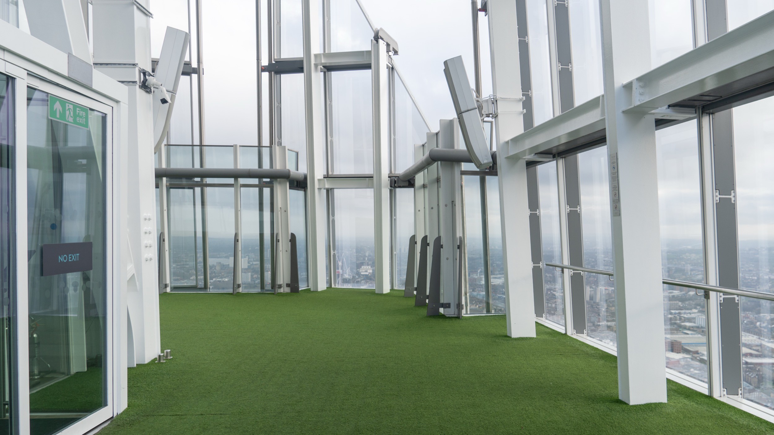 Two classic volkswagen beetles, one green, one cream.