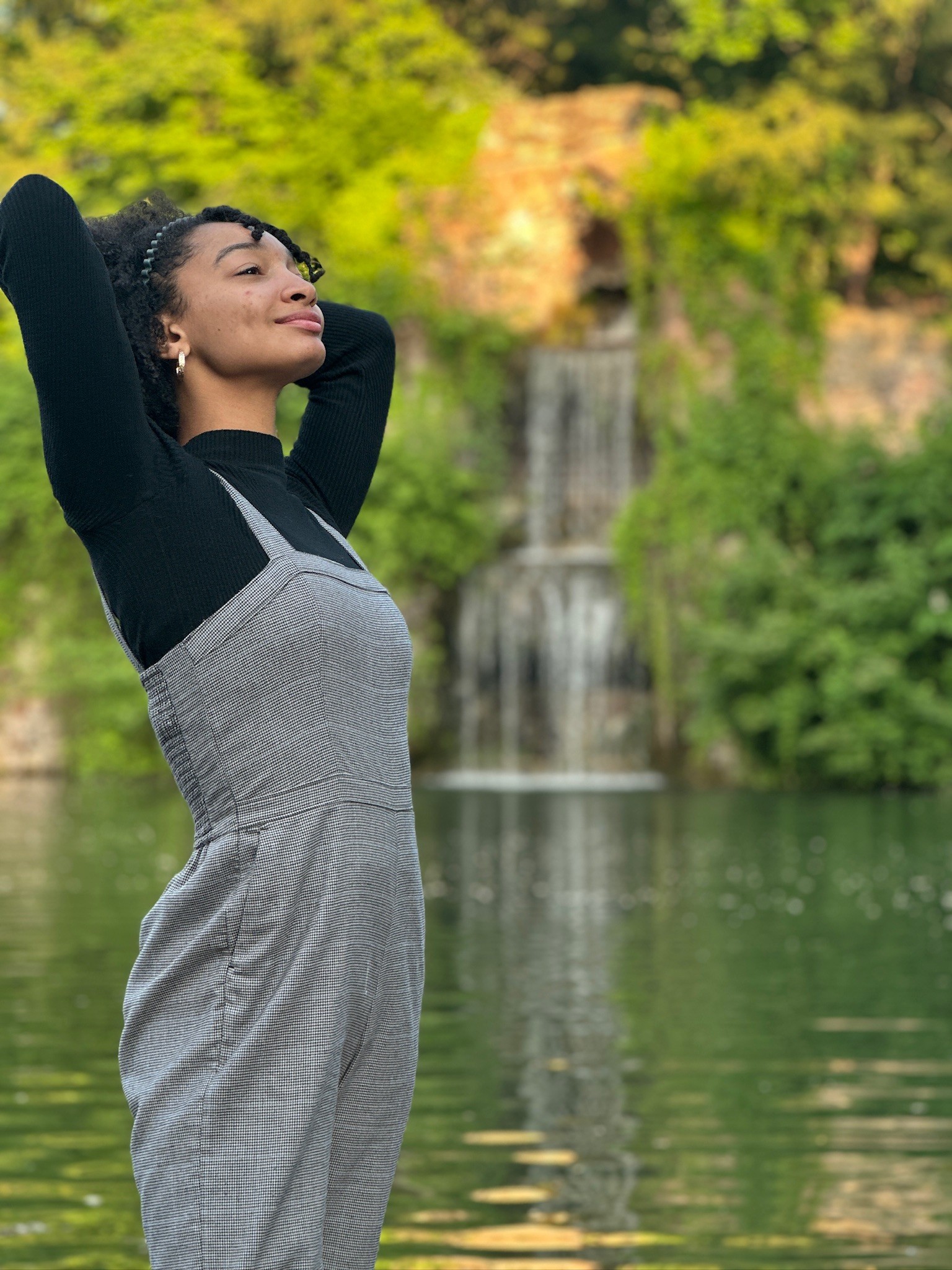 Arianna Ware posing near waterfall in front of a waterfall