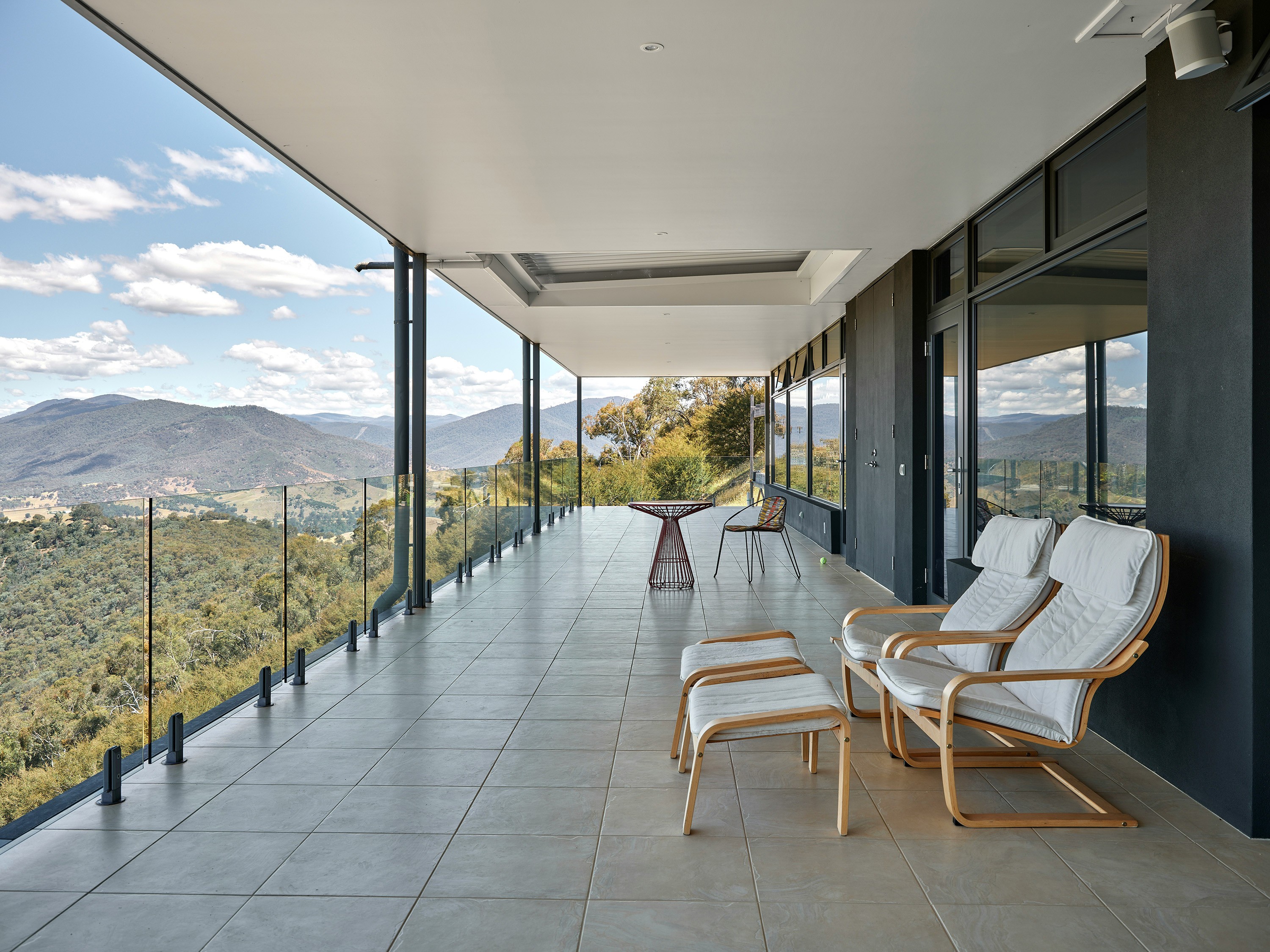 Modern balcony with mountain view and lounge chairs