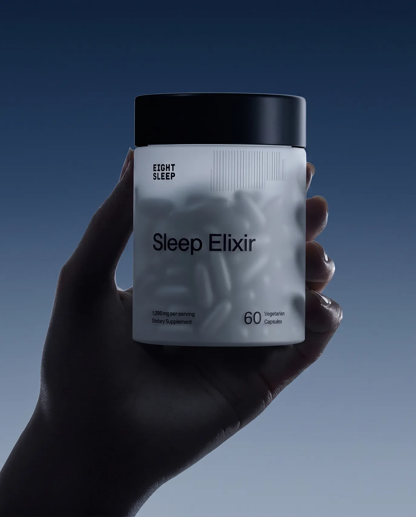 Hand holding an Eight Sleep Sleep Elixir supplement jar against a dark blue background