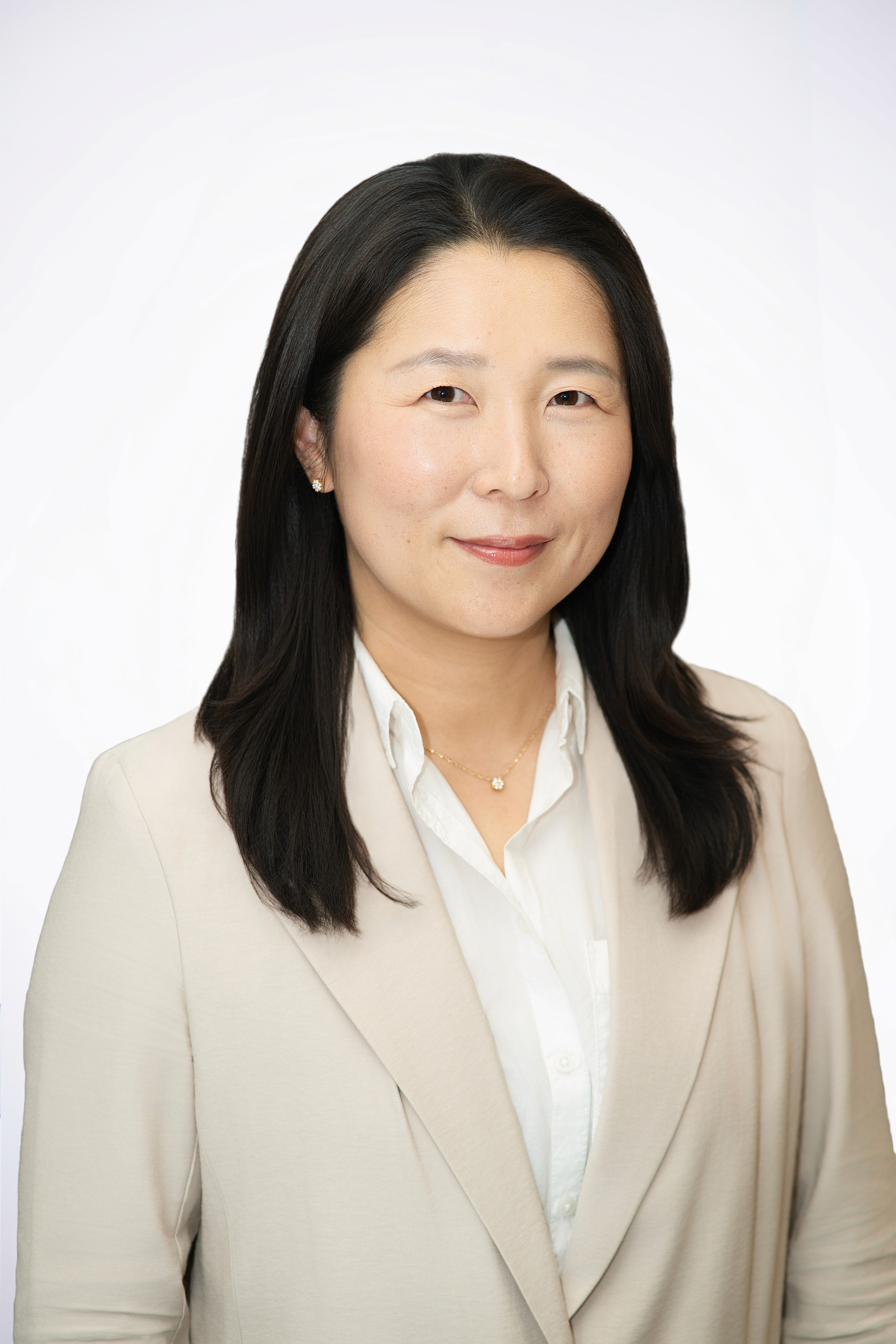 Scientist looking through a microscope in a lab.