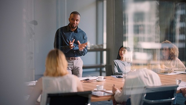 a man giving a presentation in the office.