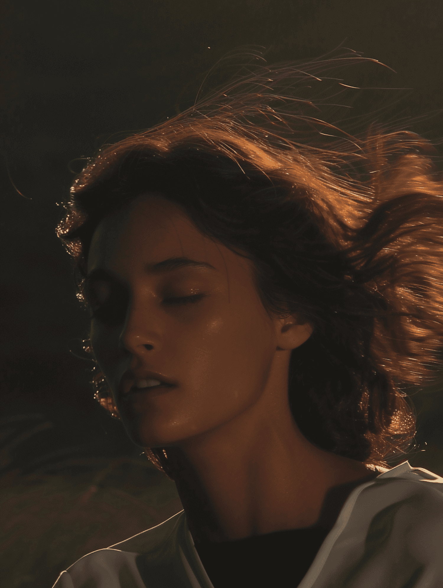 Close portrait with soft golden light and windblown hair