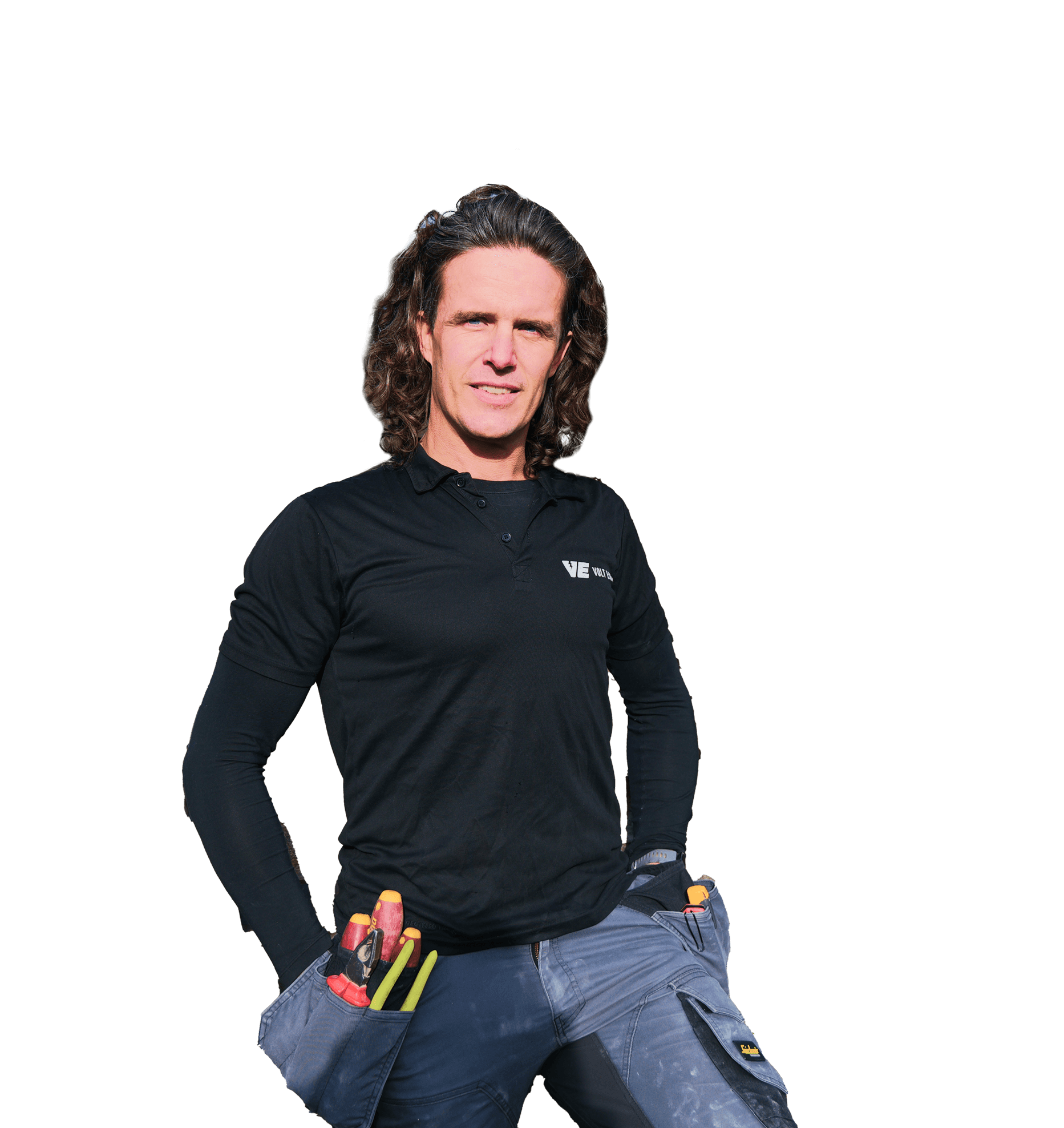 A person with long hair stands confidently, wearing a black long-sleeve shirt and gray pants.