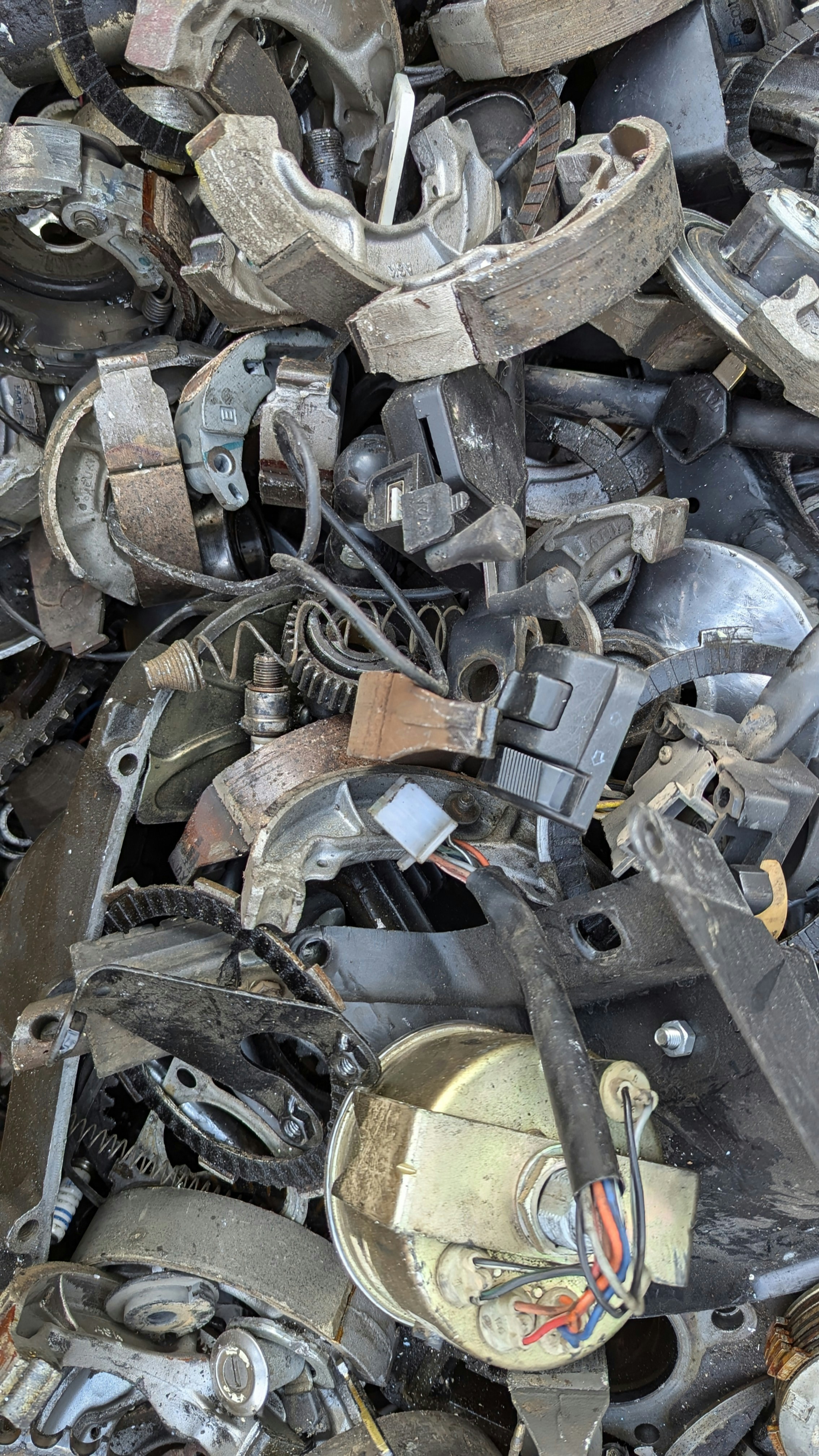 A pile of old metal parts sitting on top of each other
