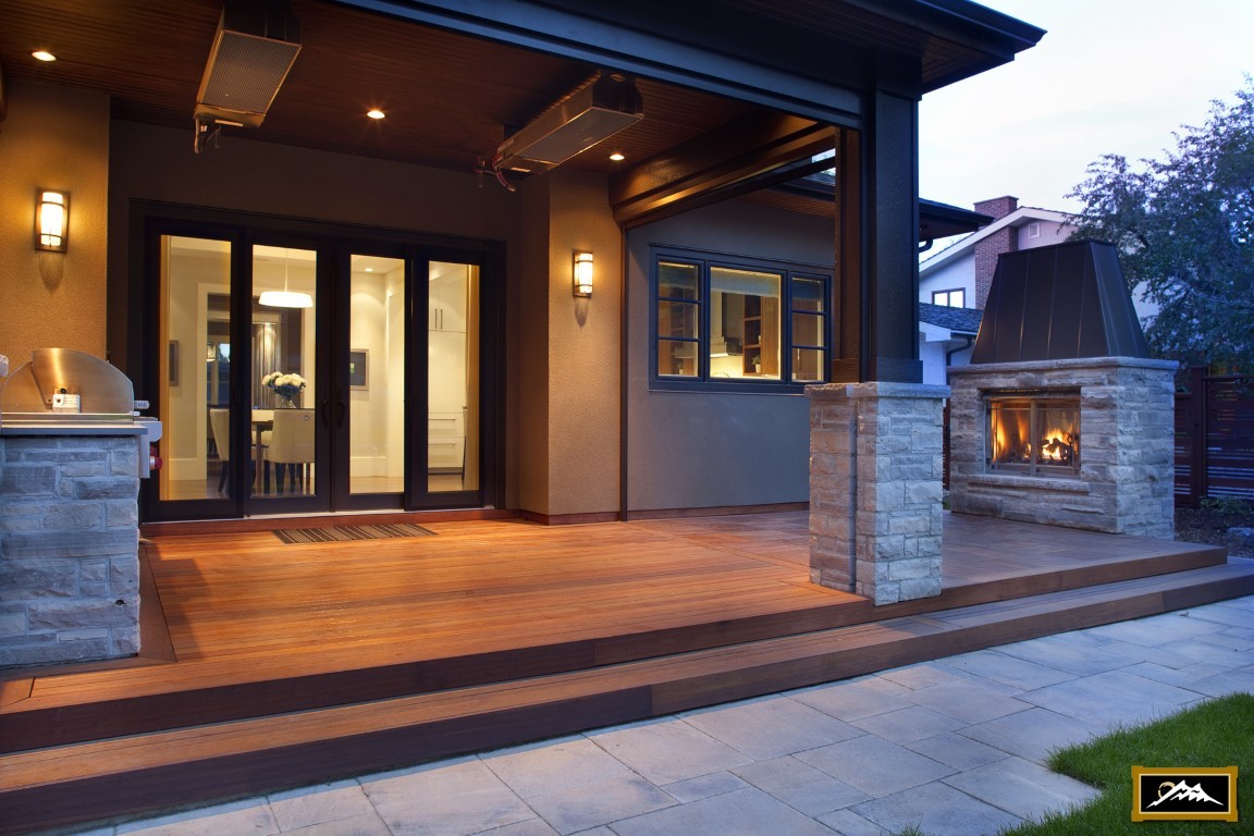 Image of KHD Homes outdoor living space with patio, fireplace, and kitchen, showcasing home design and construction.