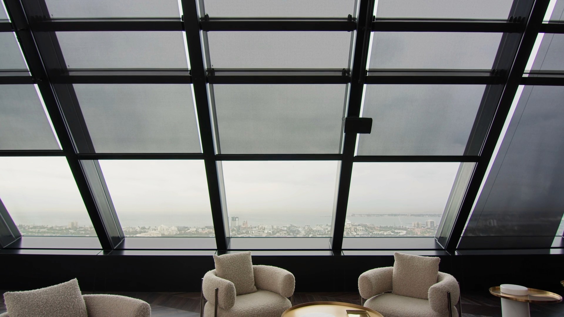 An interior architectural shot showing a ceiling with a geometric pattern of skylights