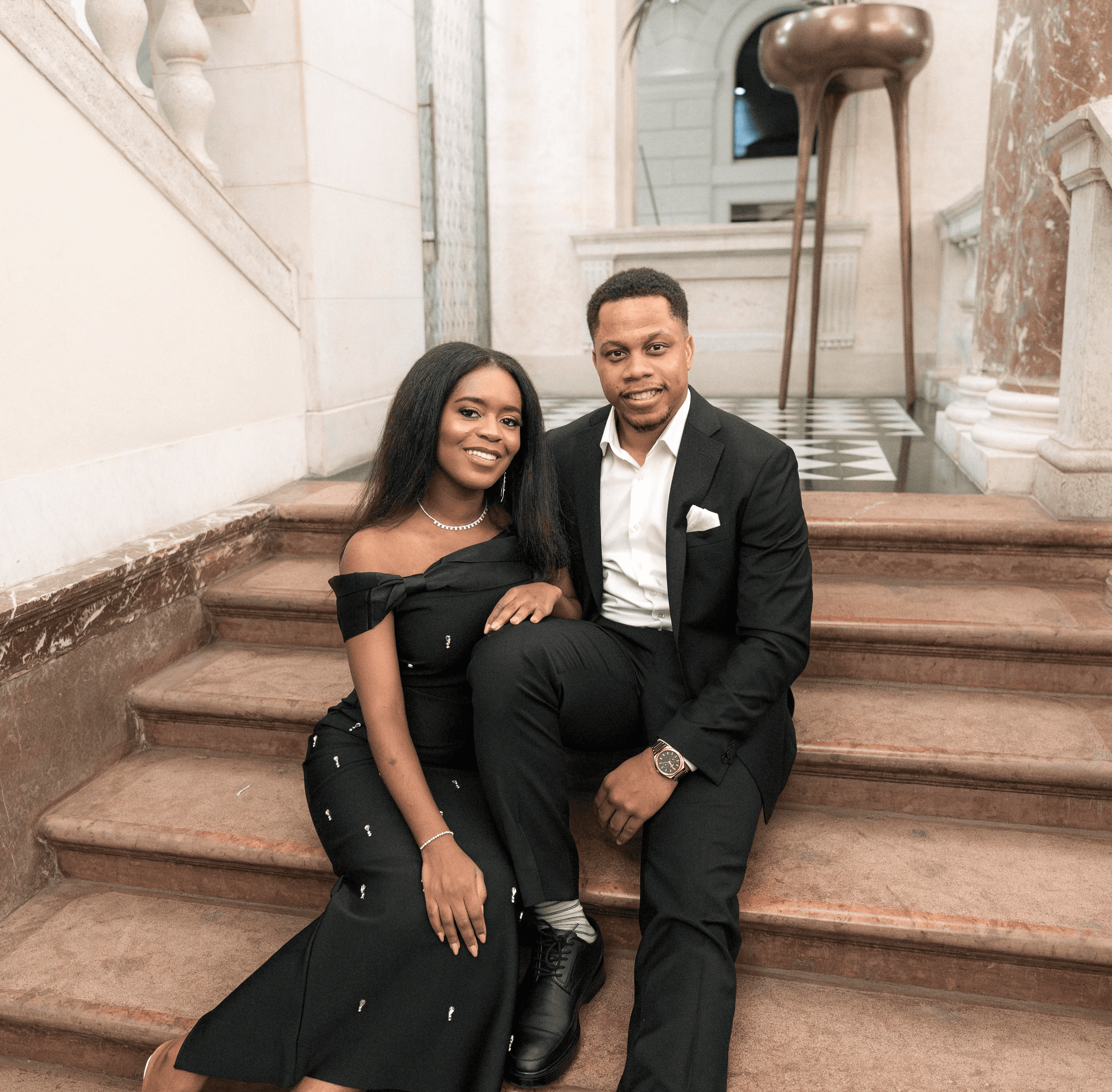 A serene pathway lined with trees leads to a distant building, bathed in warm sunlight.