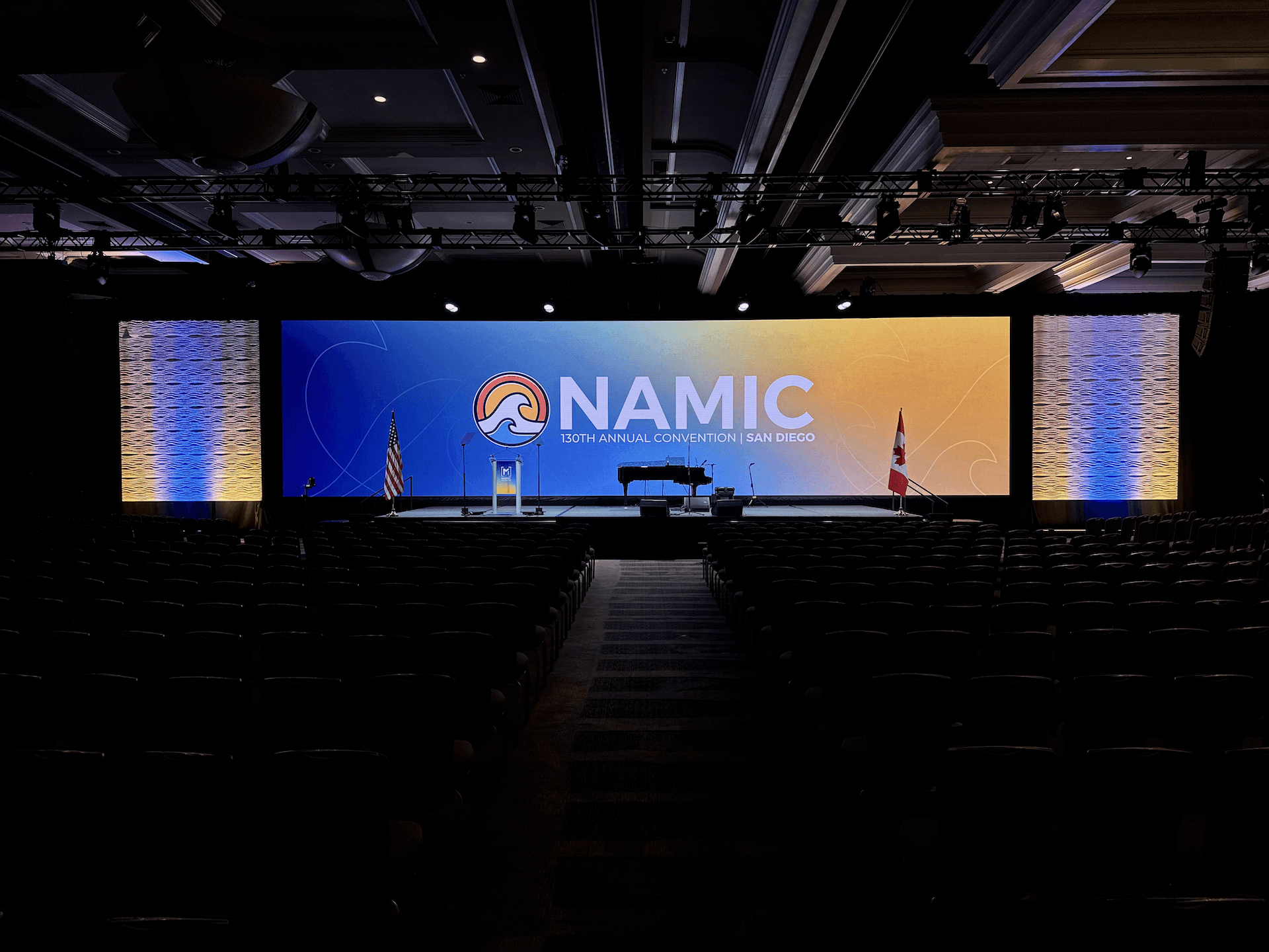 NAMIC industry conference main stage with branded screen and audience seating