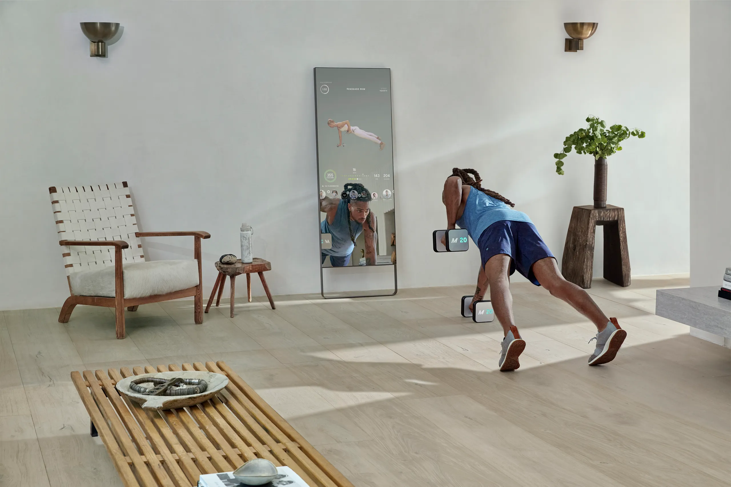 Person training with Mirror smart weights in a modern living room