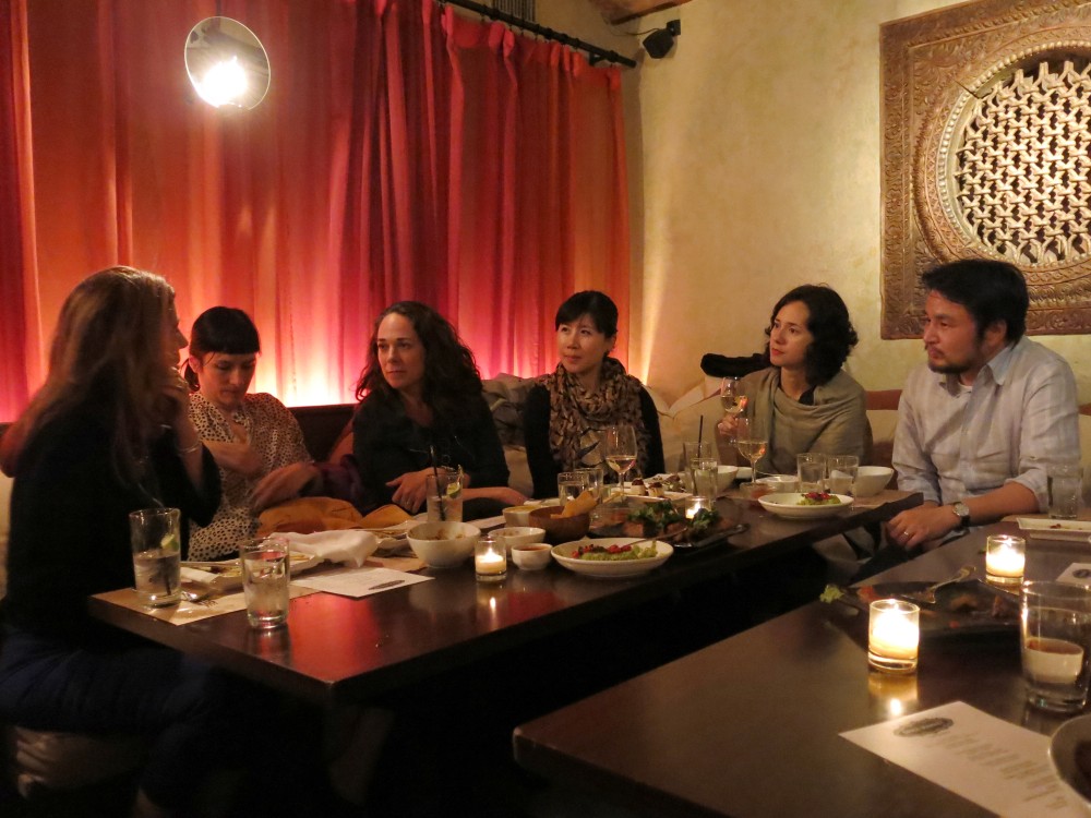 people chatting while they are sitting at a dining table in a restaurant