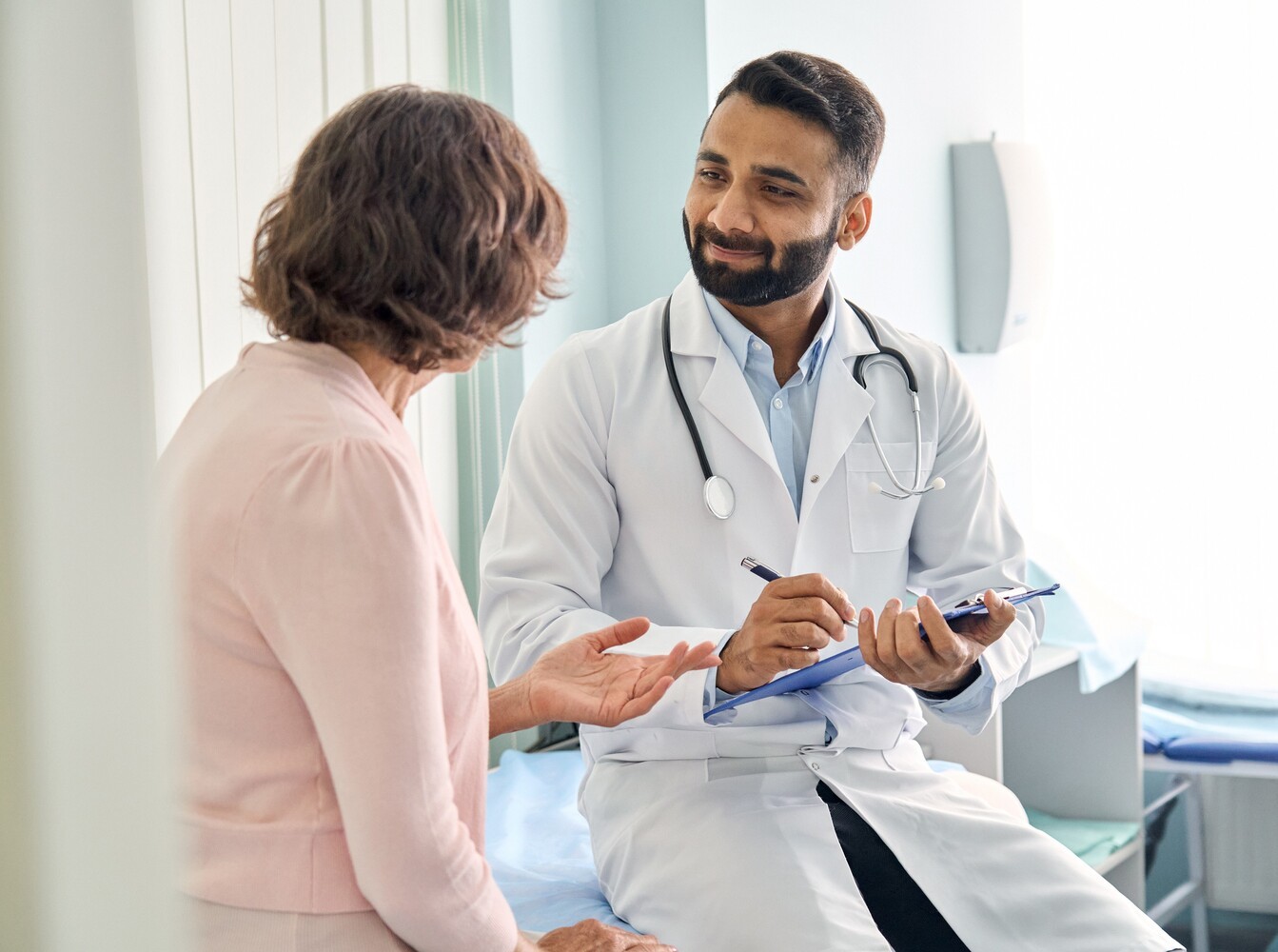 older woman talking with her doctor to discuss how often to use steam room for weight loss