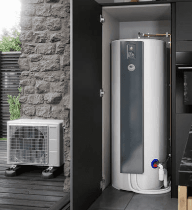 Two technicians are working on an air conditioner unit that is mounted on a wall.