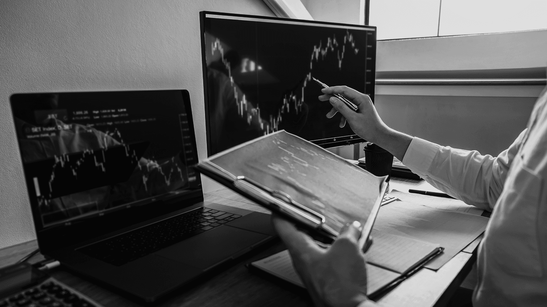 Person pointing towards monitor screen -  Hype Cycle or Real Trading Edge?