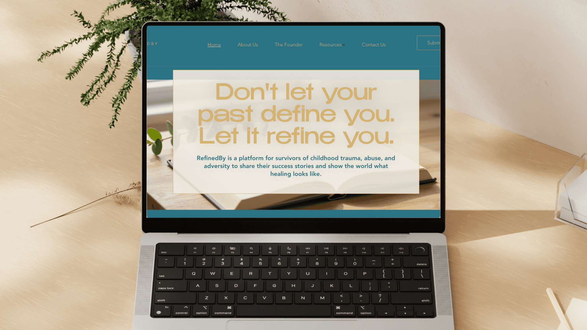 RefinedBy website homepage displayed on a laptop with the message about healing after trauma.
