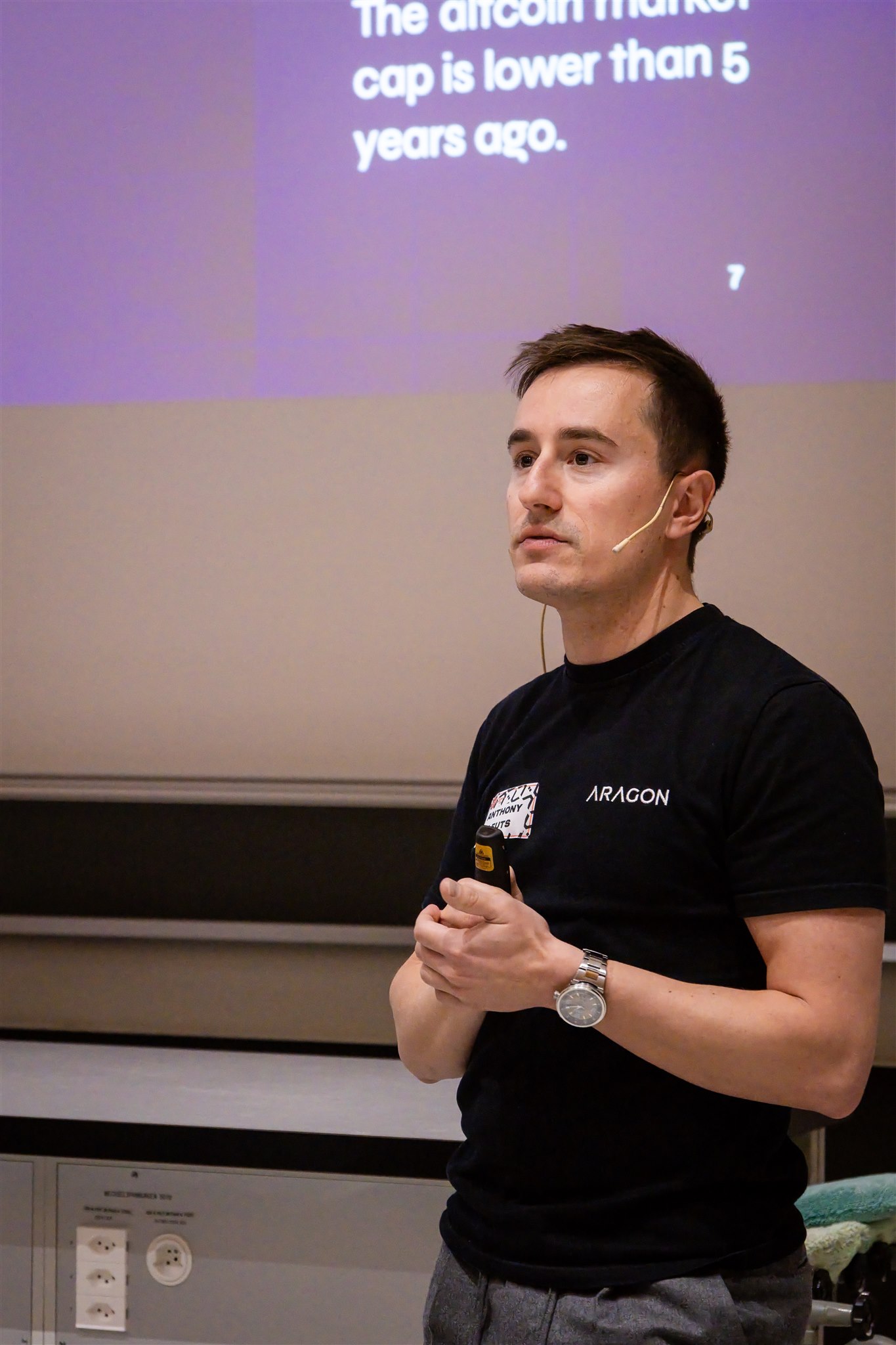 Speaker listening and preparing during EthereumZüri conference session