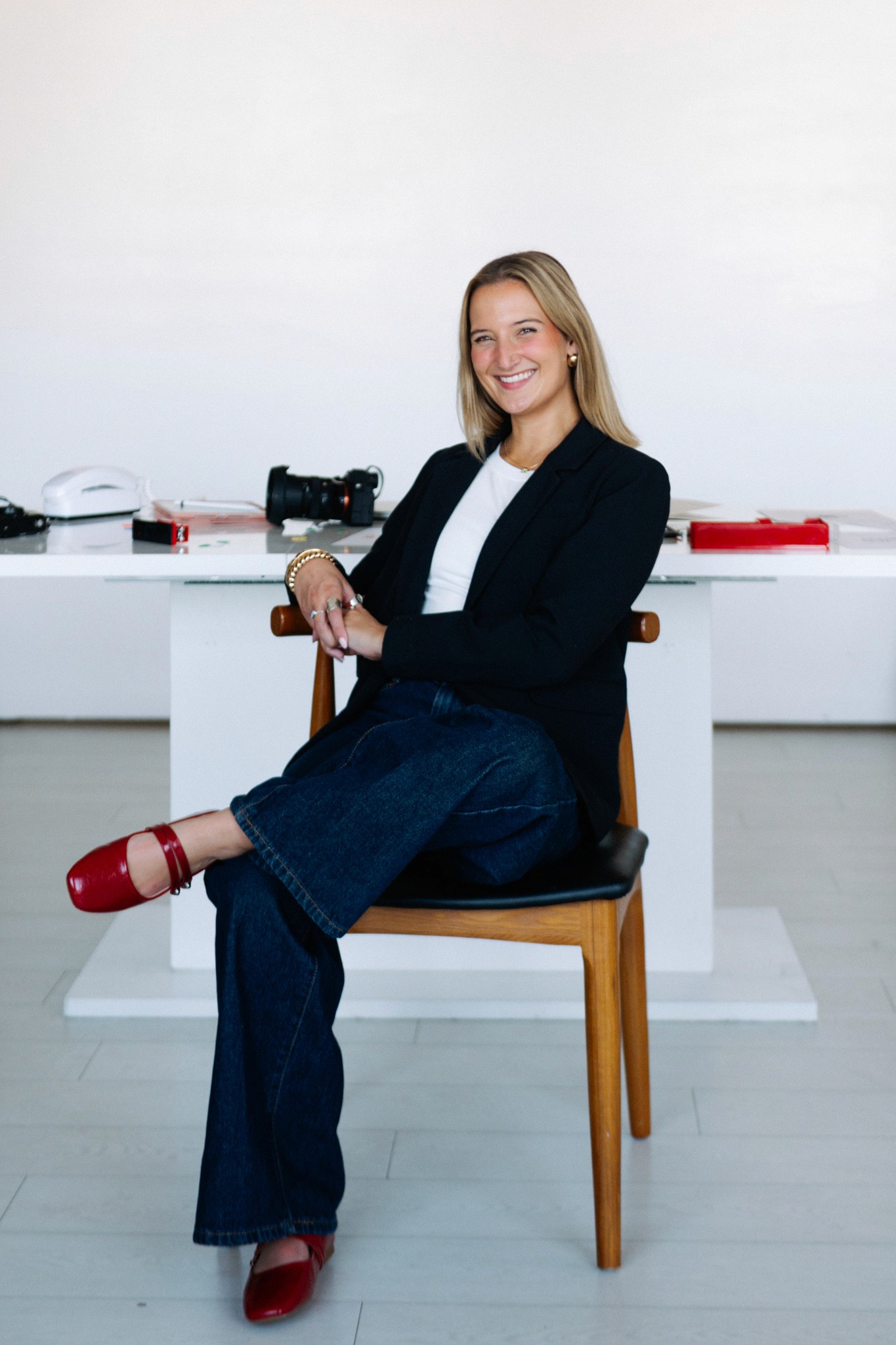 A thoughtful young person with dark hair gazes to the side, captured in soft black and white lighting.
