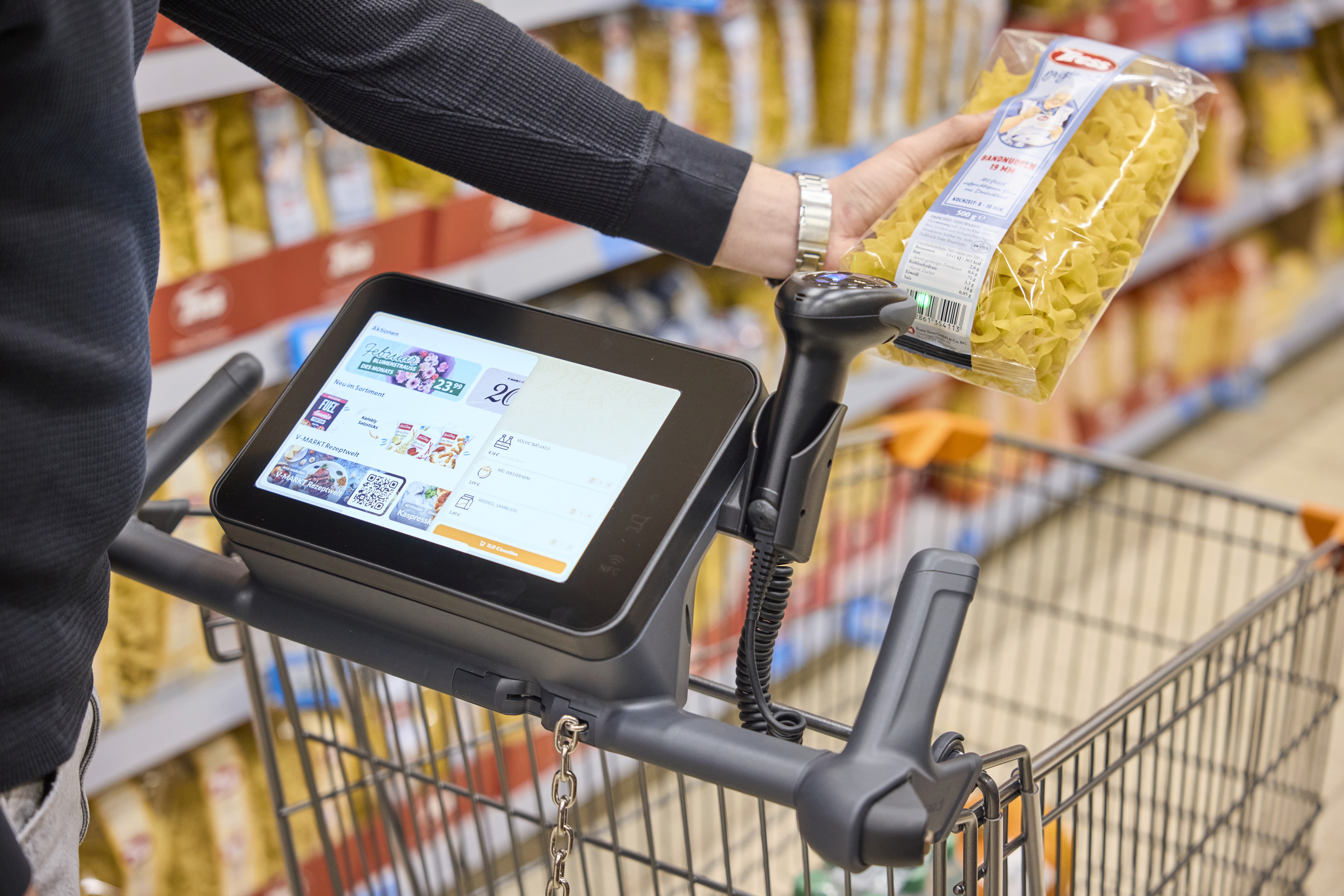 Customer scanning a product on the wanzl fastlaner smart cart - shopreme snap cart software on smart carts