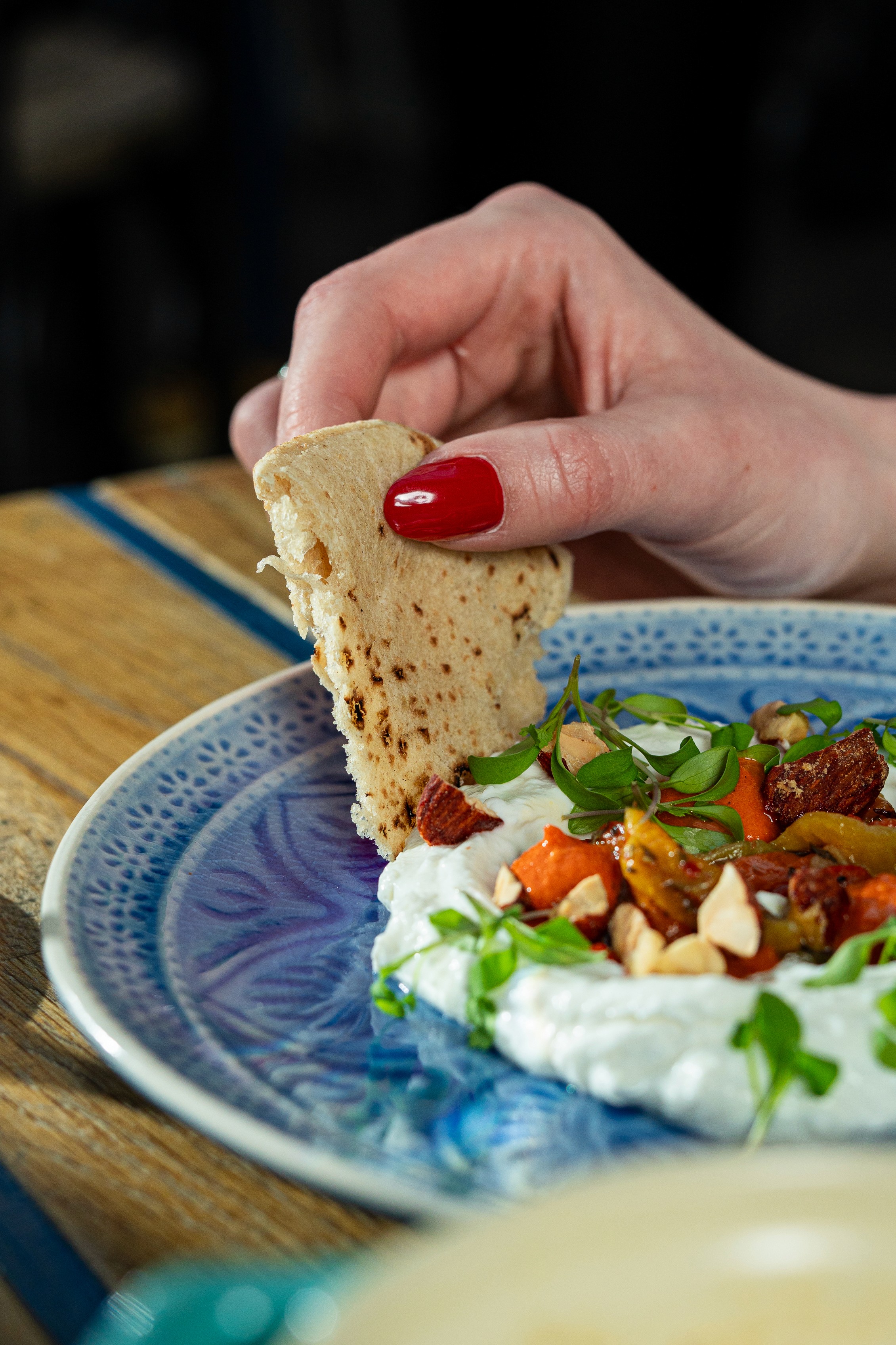 People sharing food at Mazeltov restaurant