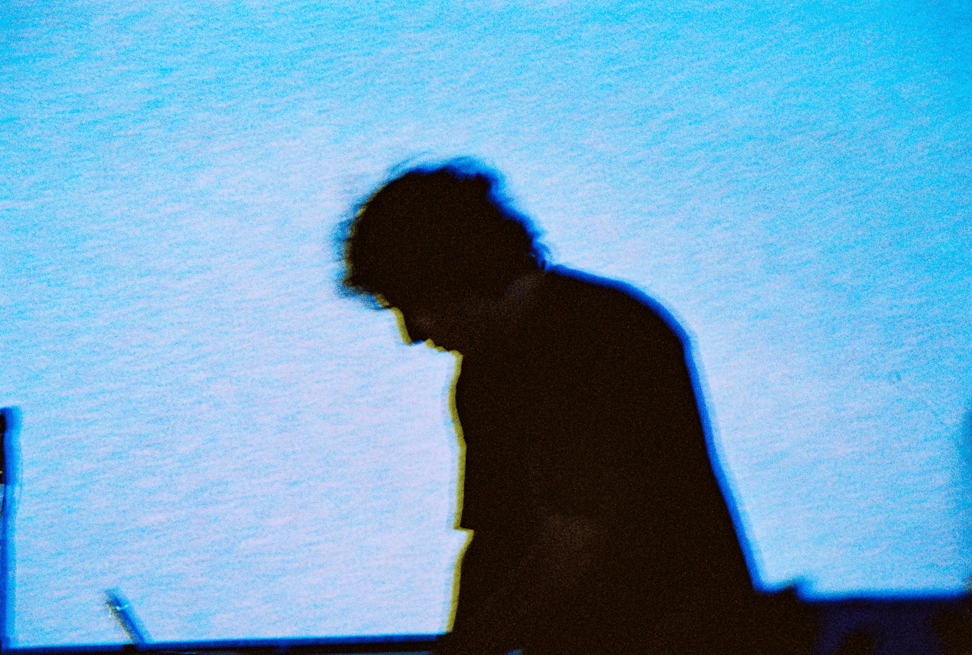 a blurry photo of a person standing in front of a wall