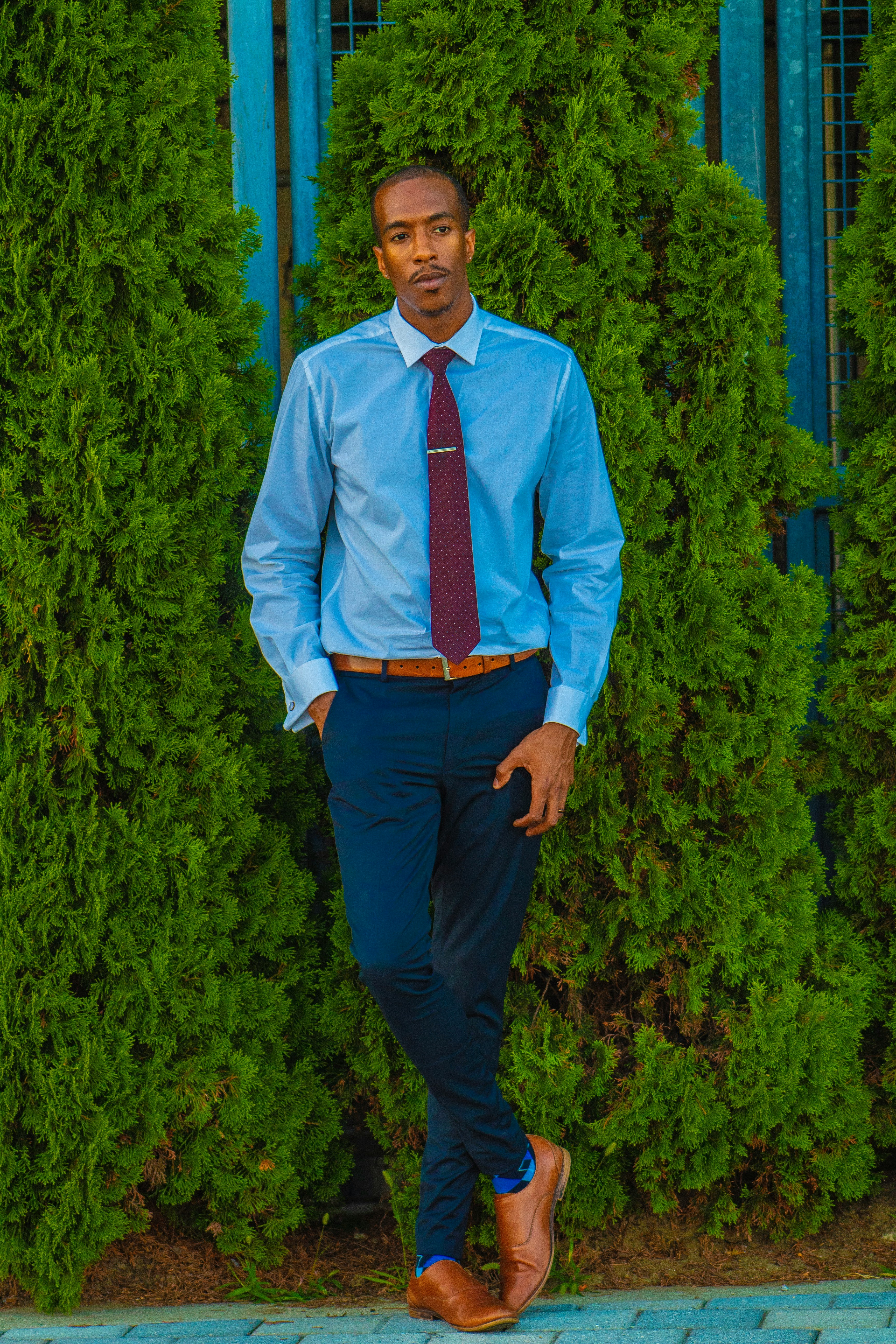 Image of a person who is wearing formal dress like shirt, tie and shoes