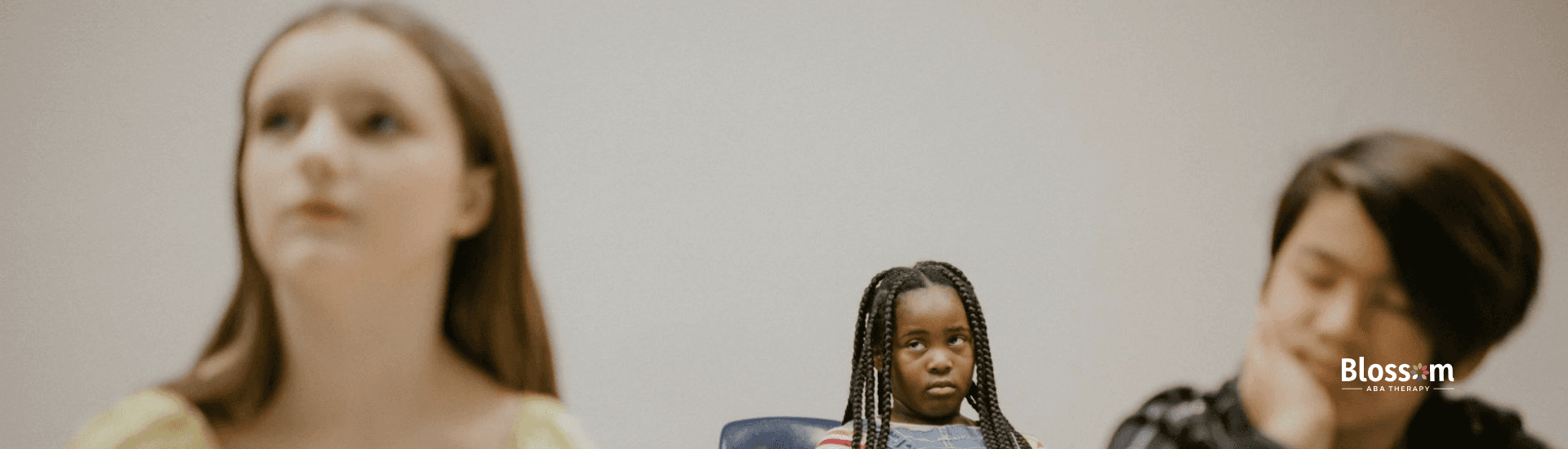 Autistic girl in a classroom looks frustrated while other students appear inattentive in Tennessee.