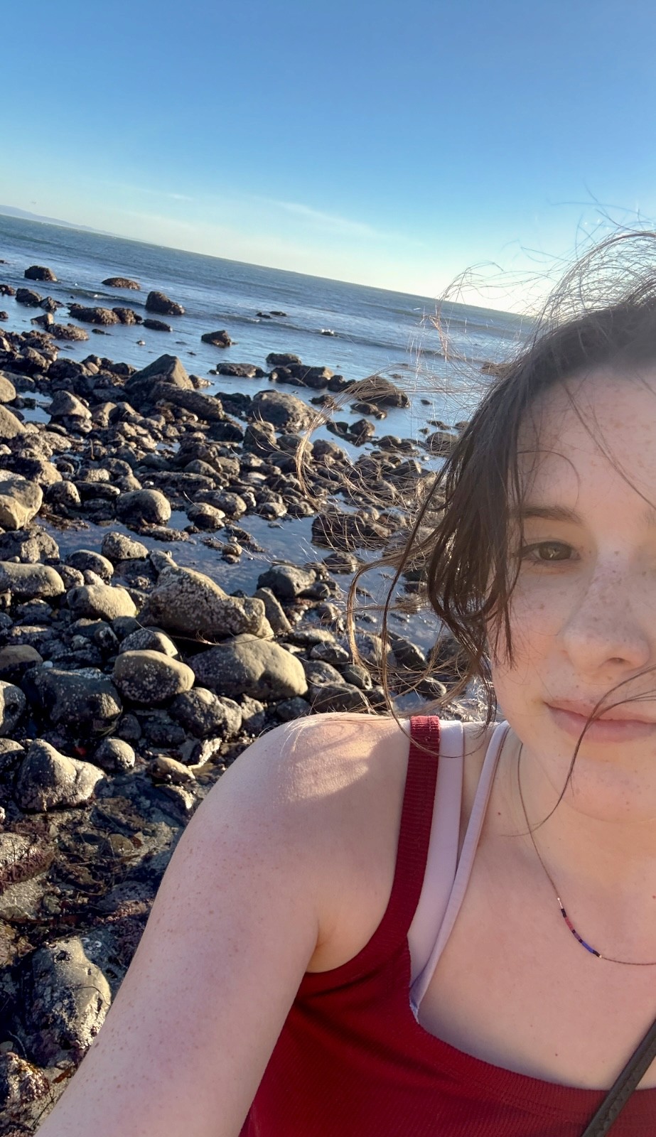 Selfie of Kathryn smiling at the tide pools in California